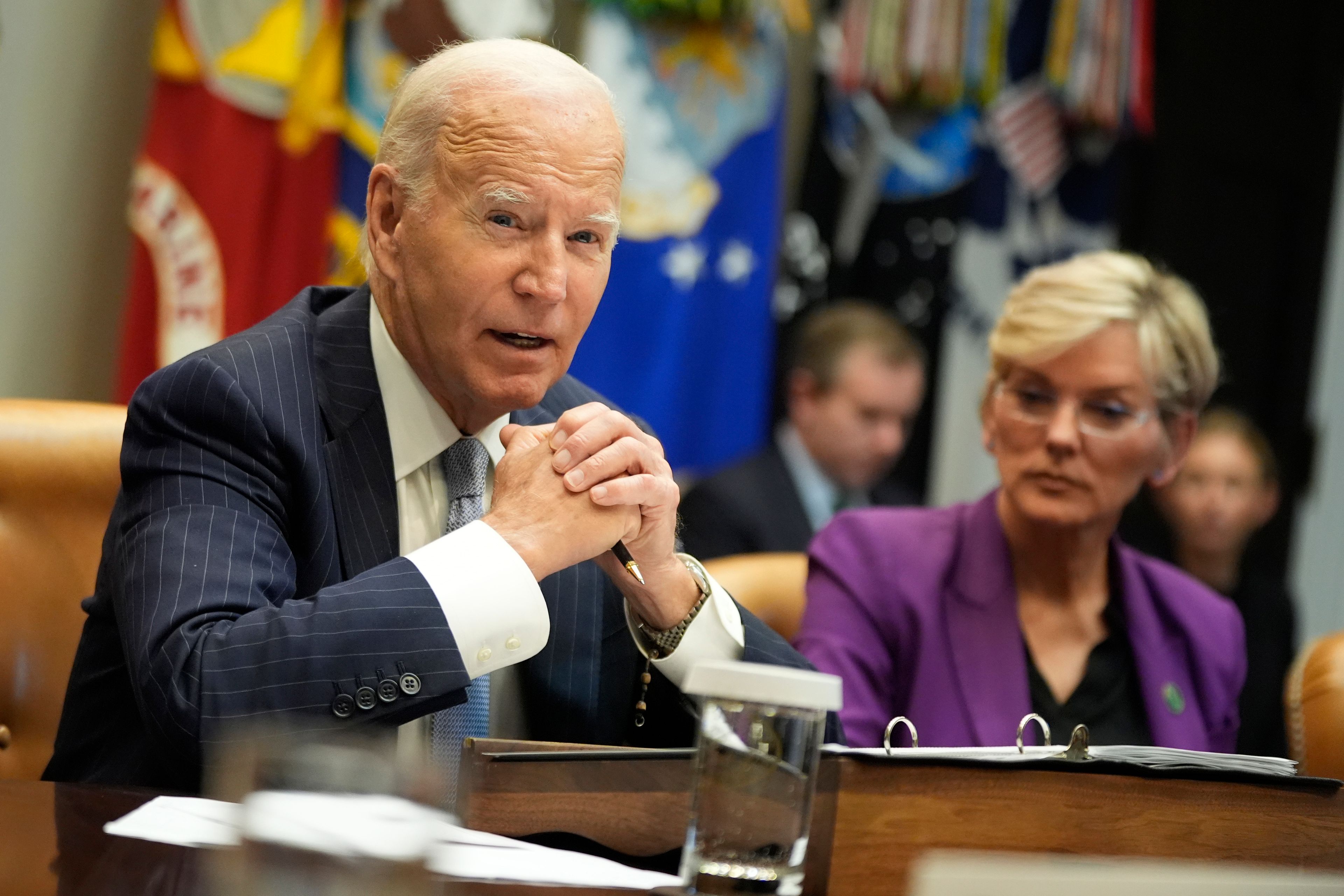 President Joe Biden speaks about the federal government's response to Hurricanes Milton and Helene as as Energy Secretary Jennifer Granholm listens, in the Roosevelt Room of the White House, Friday, Oct. 11, 2024, in Washington. (AP Photo/Manuel Balce Ceneta)