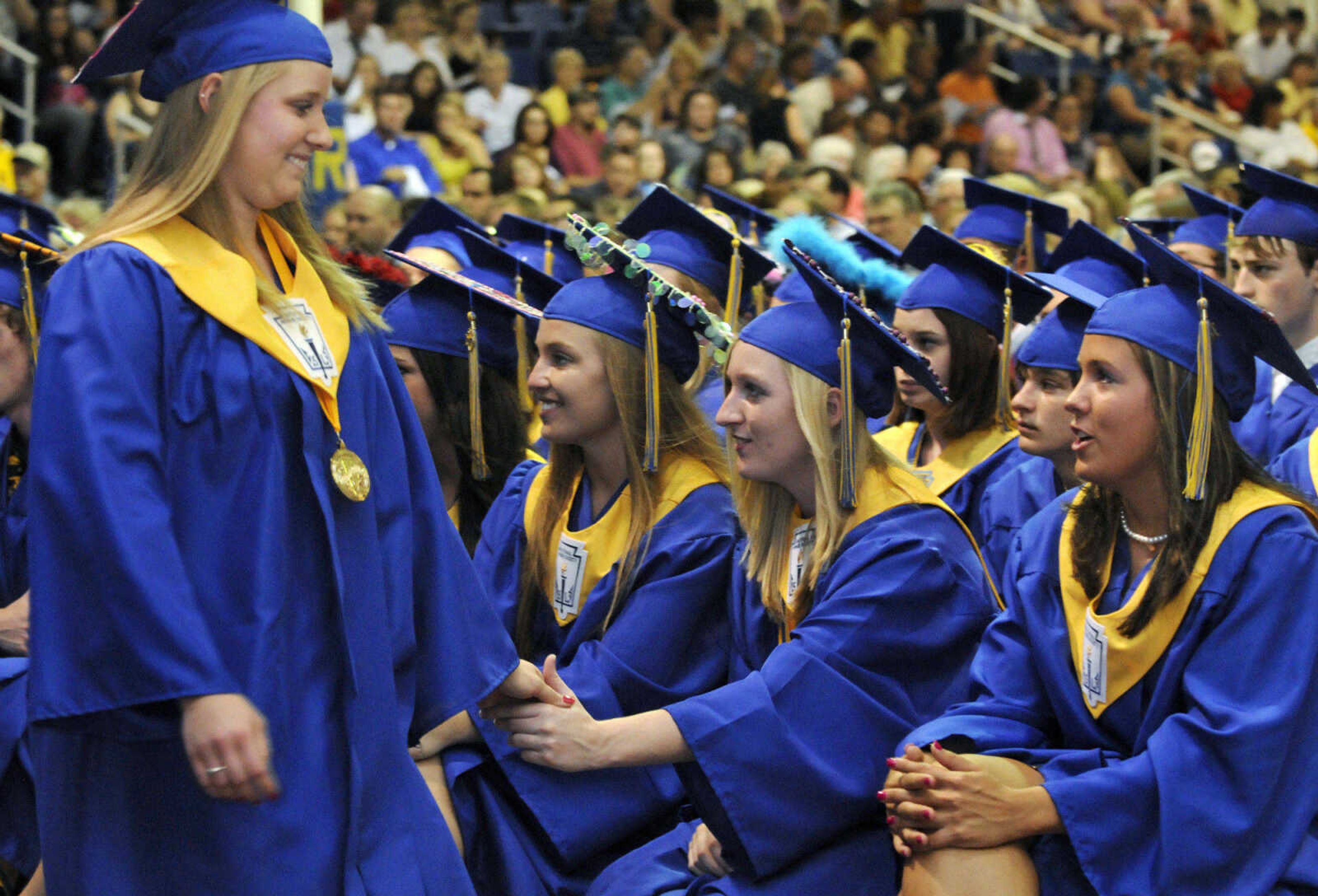 KRISTIN EBERTS ~ keberts@semissourian.com

Scott City Valedictorian Lindsey Hadley, left, is greeted by Kelly Holder, Salutatorian Holli Shemonia, and Class President Rachel Reed, from left, as she returns to her seat after addressing the graduates during Scott City High School's 2010 Commencement in the school gym on Sunday, May 23.