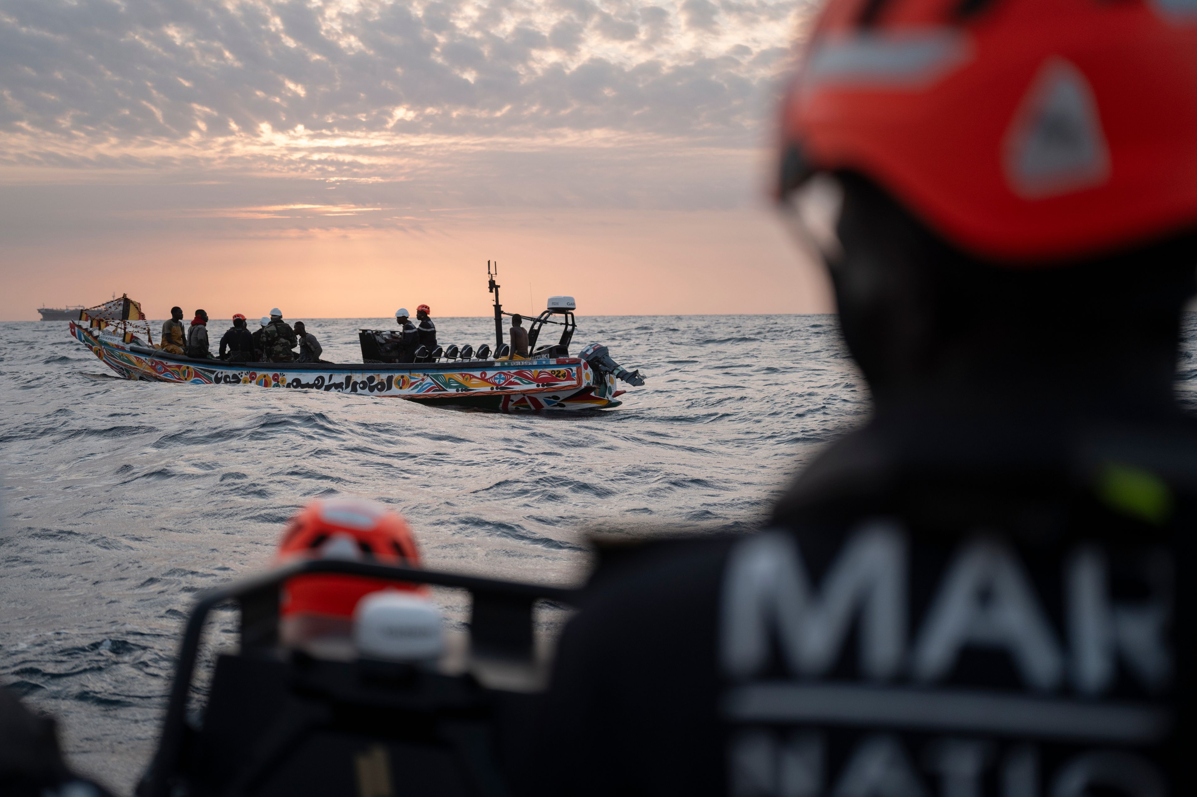 Senegalese sailors in their zodiac approach a fishermen's pirogue to check during a mission to search for migrant boats near the coast of Dakar, Senegal, Saturday, Nov. 16, 2024. (AP Photo/Sylvain Cherkaoui)