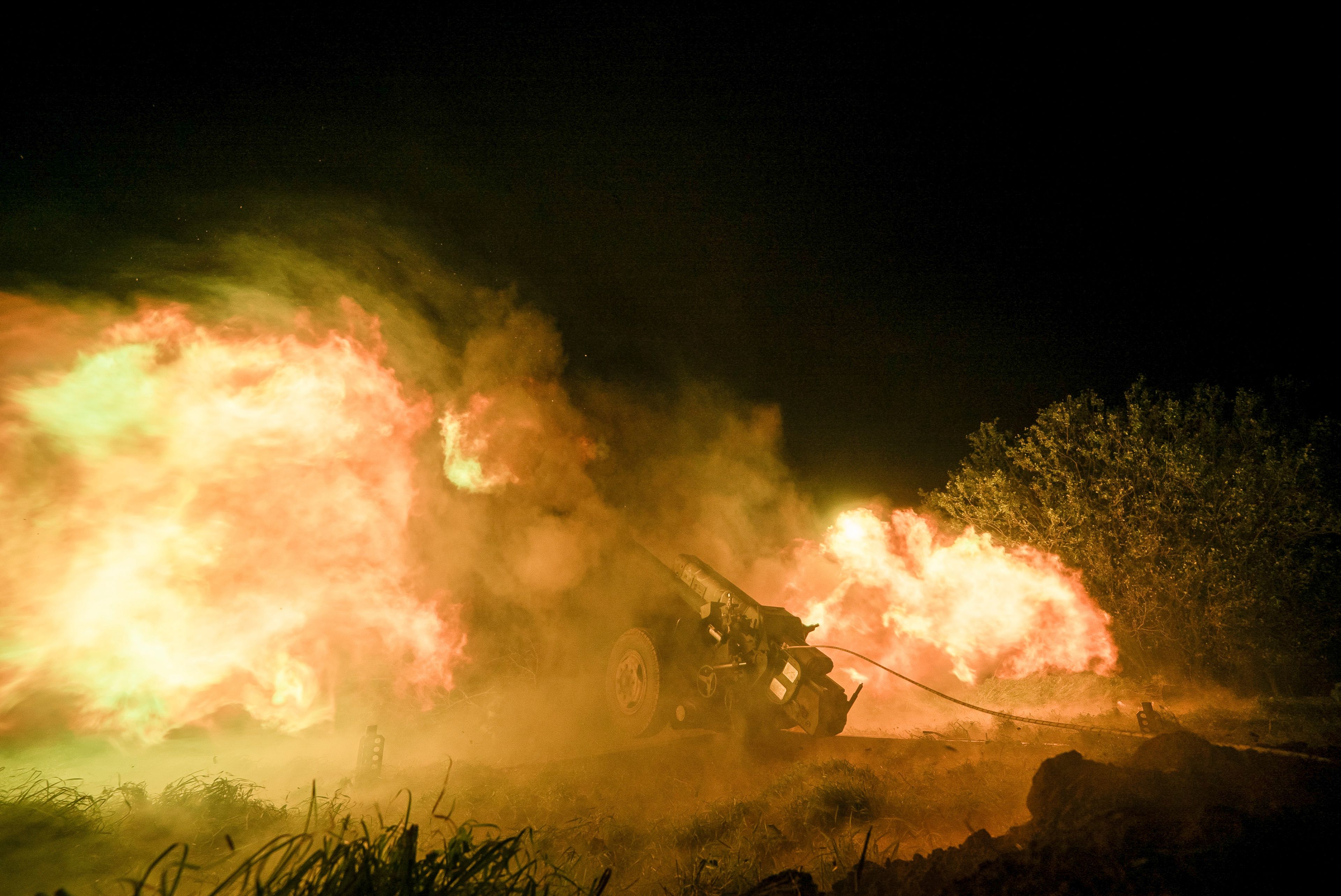 Ukrainian servicemen fire from a 122mm artillery cannon towards Russian positions in Kherson region, Ukraine, Sunday Oct. 27, 2024. (AP Photo/Marko Ivkov)