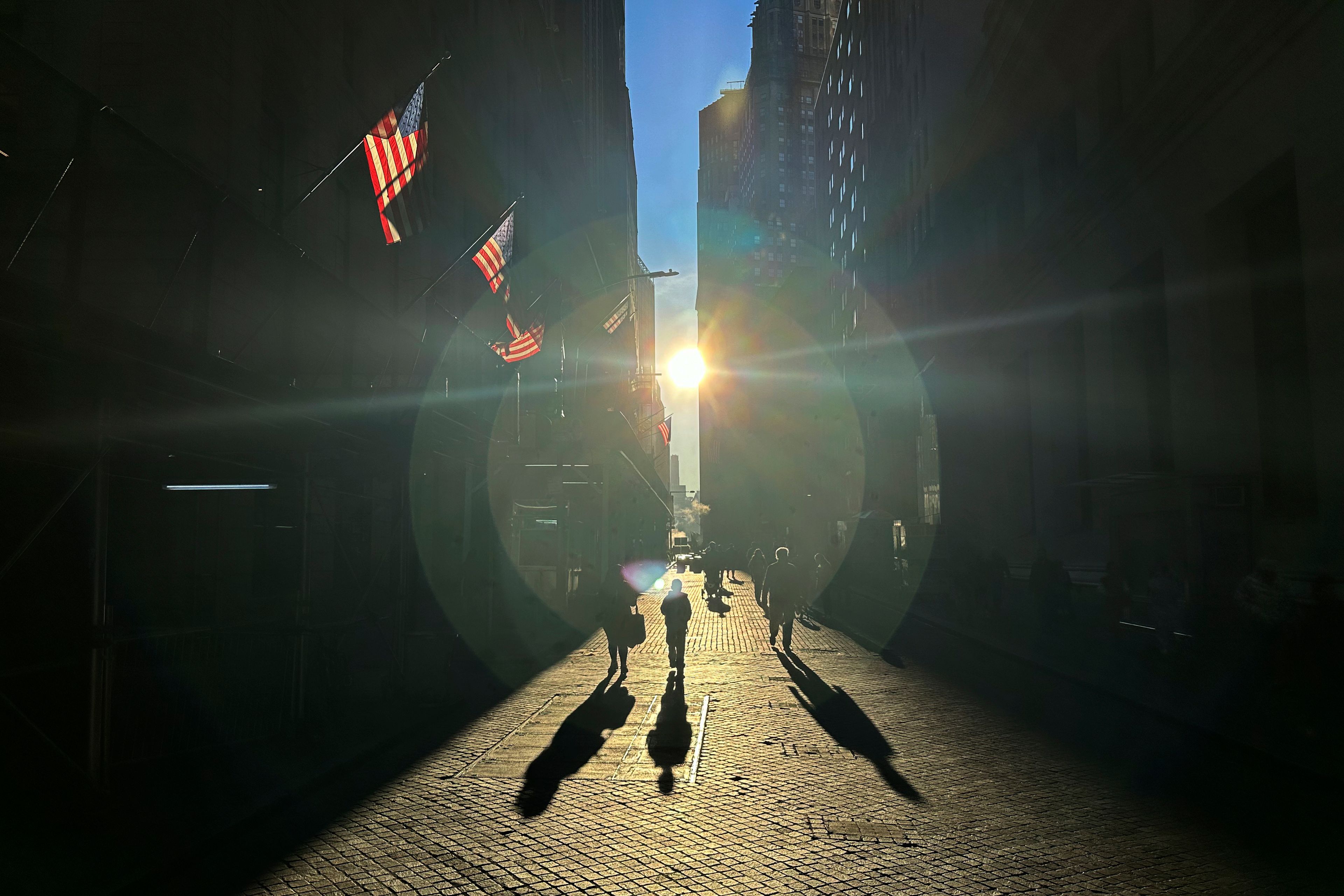 FILE - The morning sun shines on Wall Street in New York's Financial District on Tuesday, Nov. 19, 2024. (AP Photo/Peter Morgan)