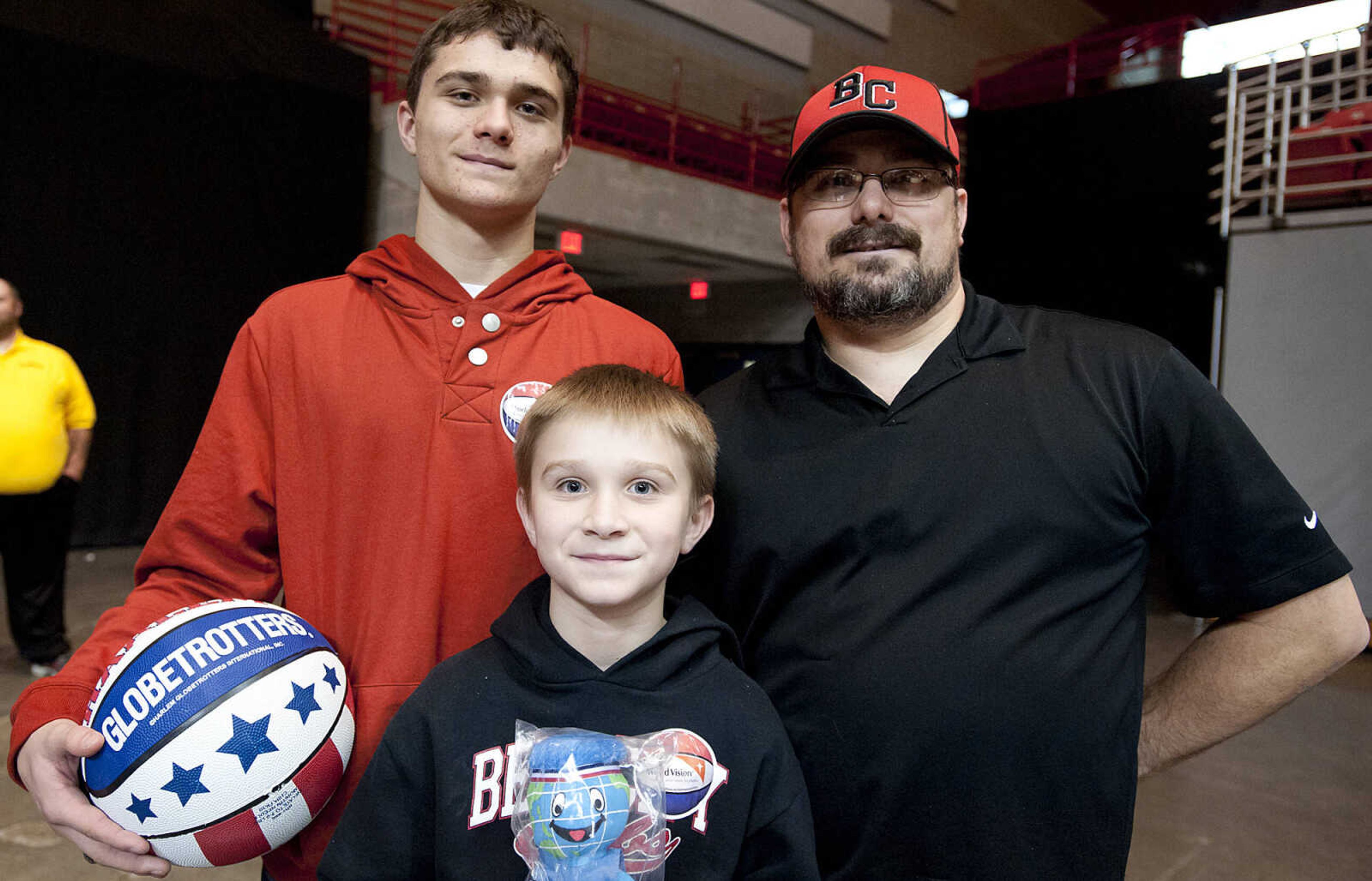 Daniel Maddox, right, Bryson Maddox, 9, and Peyton Maddox, 15, at the Original Harlem Globetrotters' performance Monday, Jan. 13, at the Show Me Center.