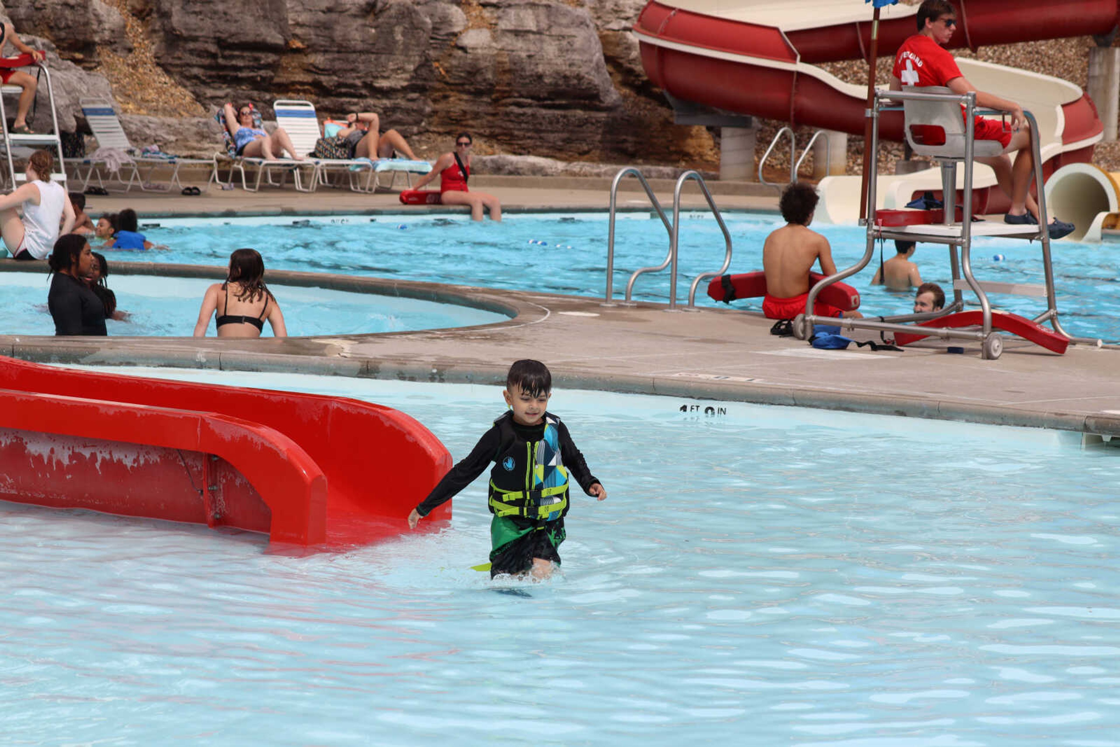 Rohan Javvaji walking back to dry land after making his way down the slide at the Cape Splash water park.