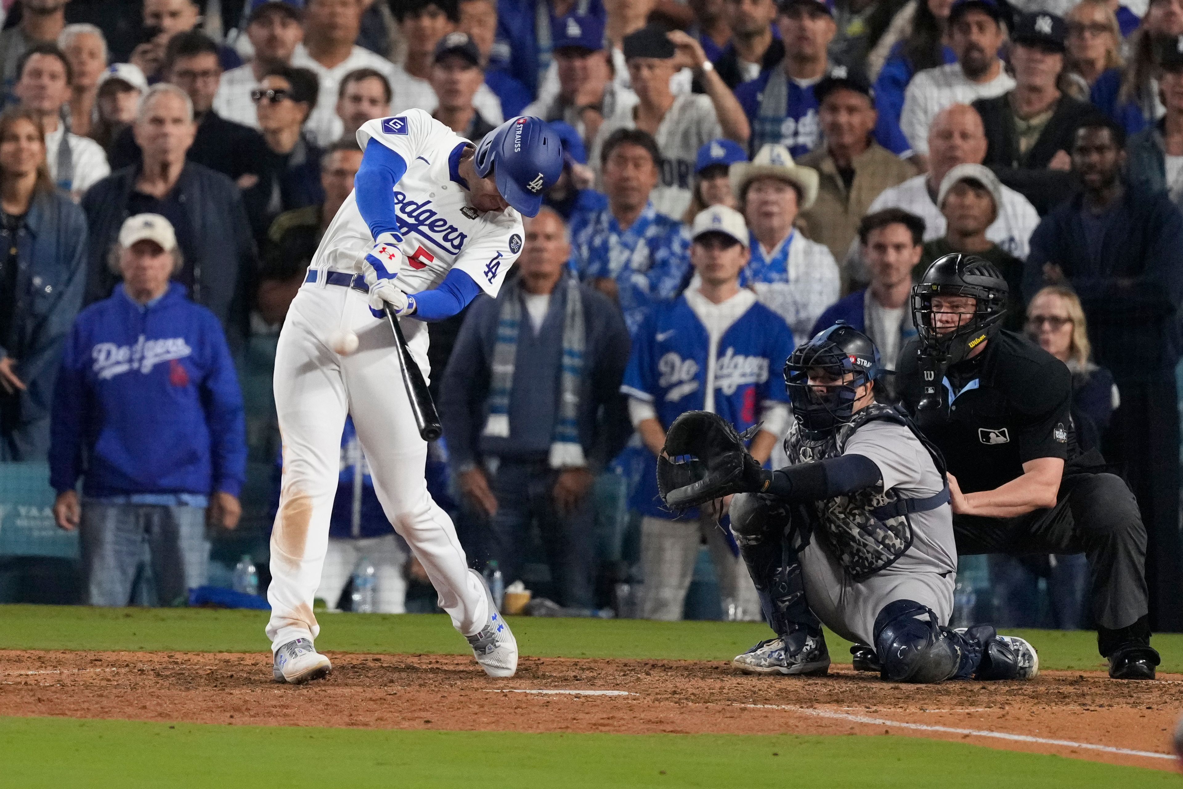 Los Angeles Dodgers' Freddie Freeman connects for a walk-off grand slam home run during the 10th inning in Game 1 of the baseball World Series against the New York Yankees, Friday, Oct. 25, 2024, in Los Angeles. (AP Photo/Mark J. Terrill)