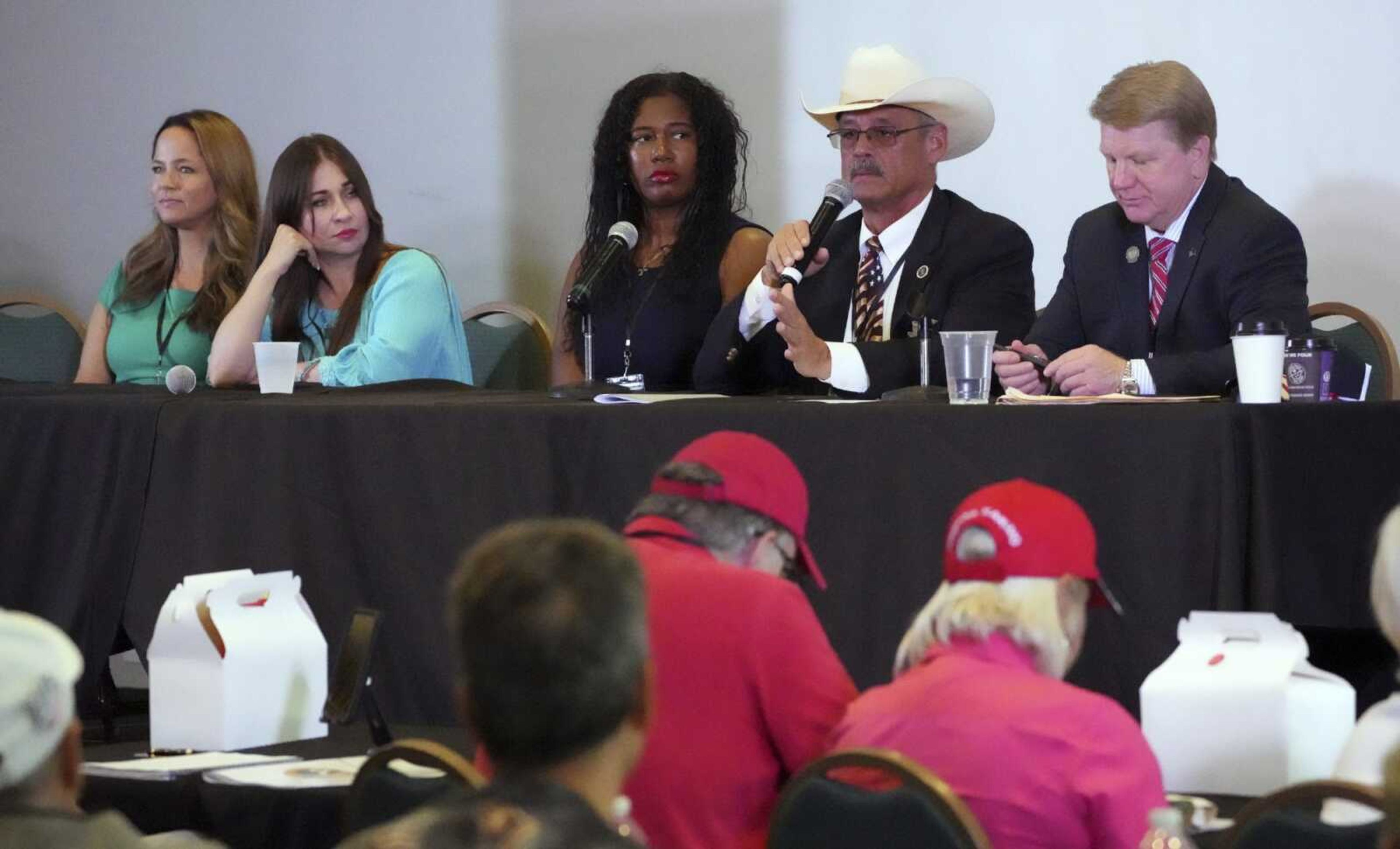 From left, Rachel Hamm, former California secretary of state candidate; Audrey Trujillo, candidate for New Mexico secretary of state; Kristina Karamo, candidate for Michigan secretary of state; Mark Finchem, candidate for Arizona secretary of state; and Jim Marchant, candidate for Nevada secretary of state, attend a conference promoting conspiracy theories about voting machines and discredited claims about the 2020 presidential election, Sept. 10 at a hotel in West Palm Beach, Flodida.