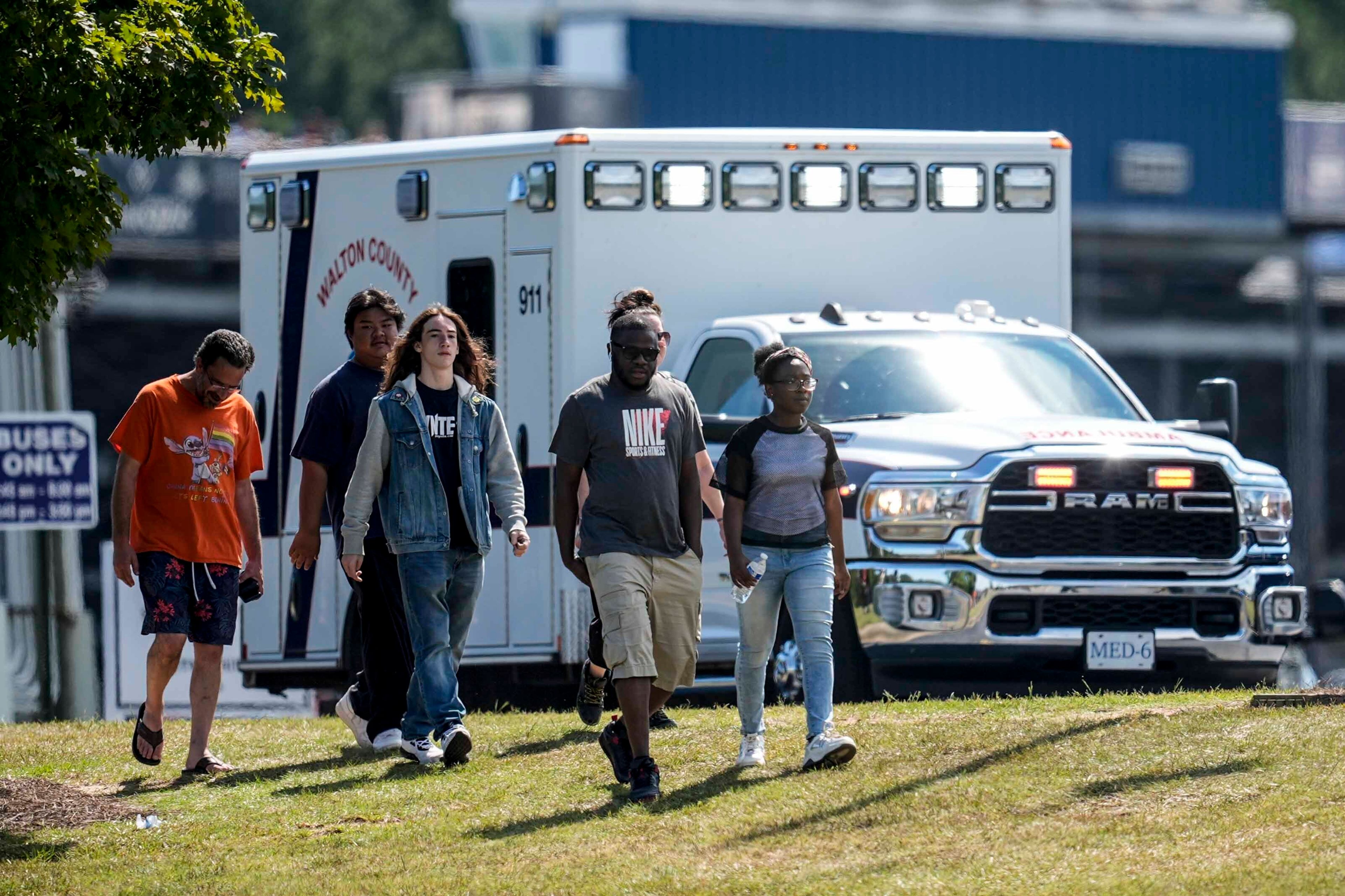 Students and parents walk off campus at Apalachee High School, Wednesday, Sept. 4, 2024, in Winder, Ga. A shooting at the Georgia high school Wednesday caused an unknown number of injuries and a suspect was arrested in a chaotic scene. (AP Photo/Mike Stewart)