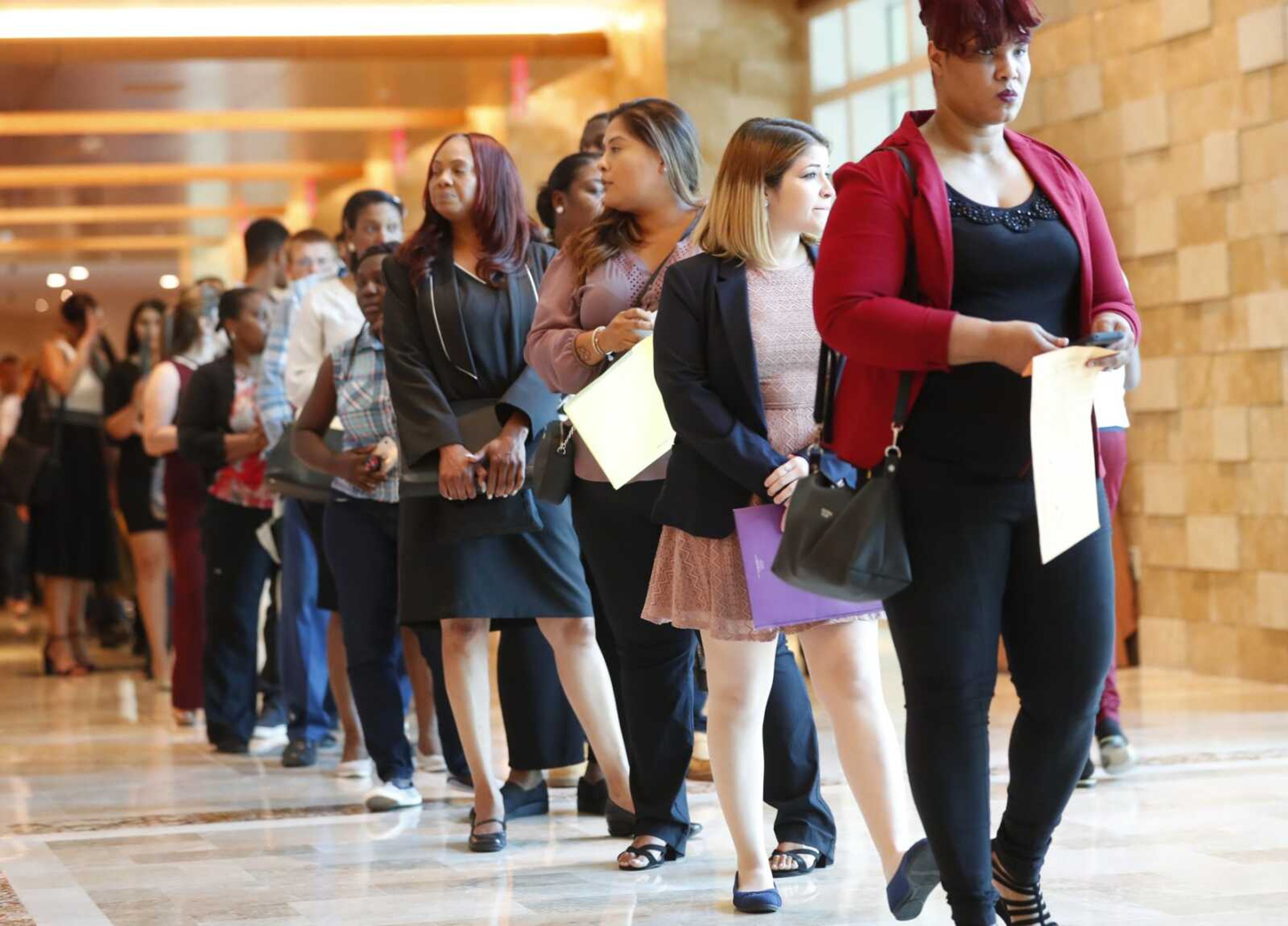 Job applicants line up at the Seminole Hard Rock Hotel & Casino Hollywood during a job fair June 4 in Hollywood, Florida.