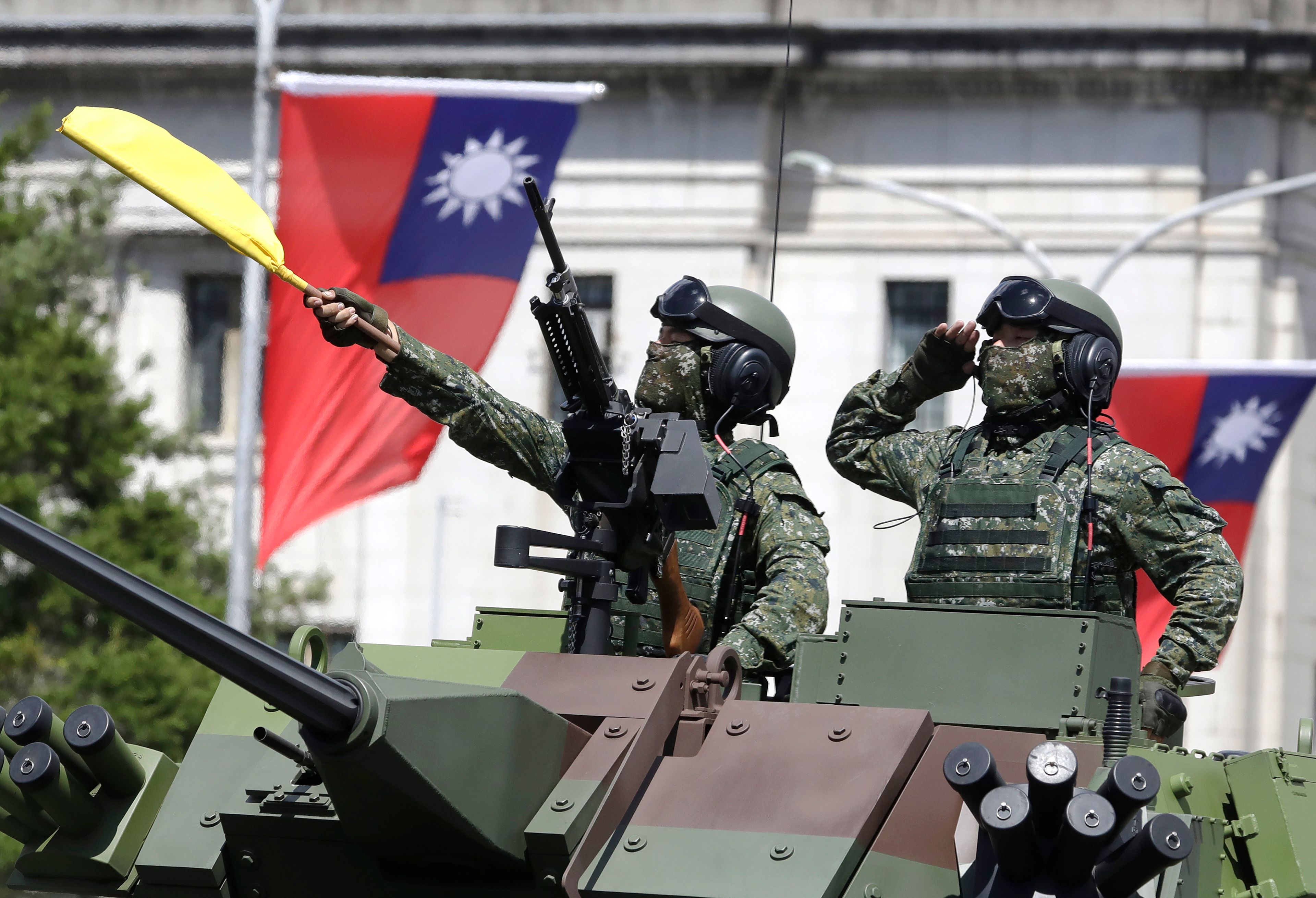 FILE - Taiwanese soldiers salute during National Day celebrations in front of the Presidential Building in Taipei, Taiwan, on Oct. 10, 2021. (AP Photo/Chiang Ying-ying, File)