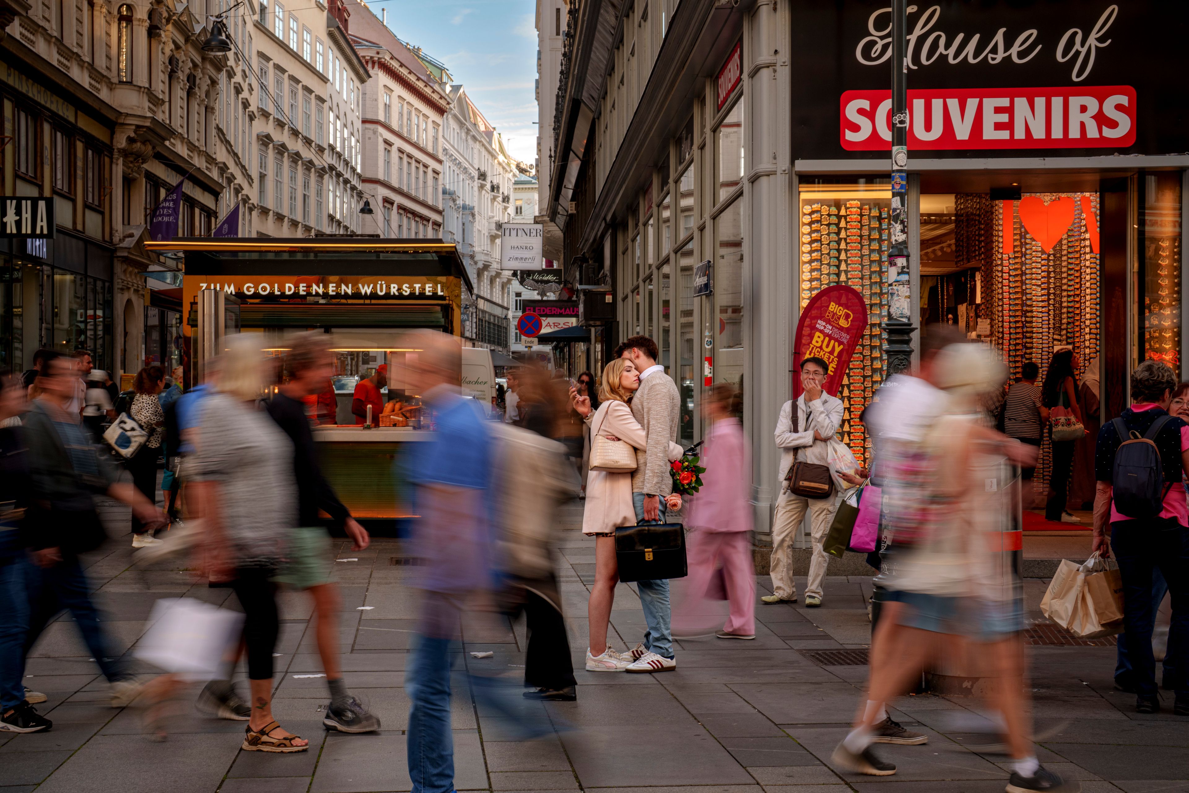 Annika and Moritz embrace as people walk by in Vienna, Austria, Thursday, Sept. 26, 2024. (AP Photo/Andreea Alexandru)