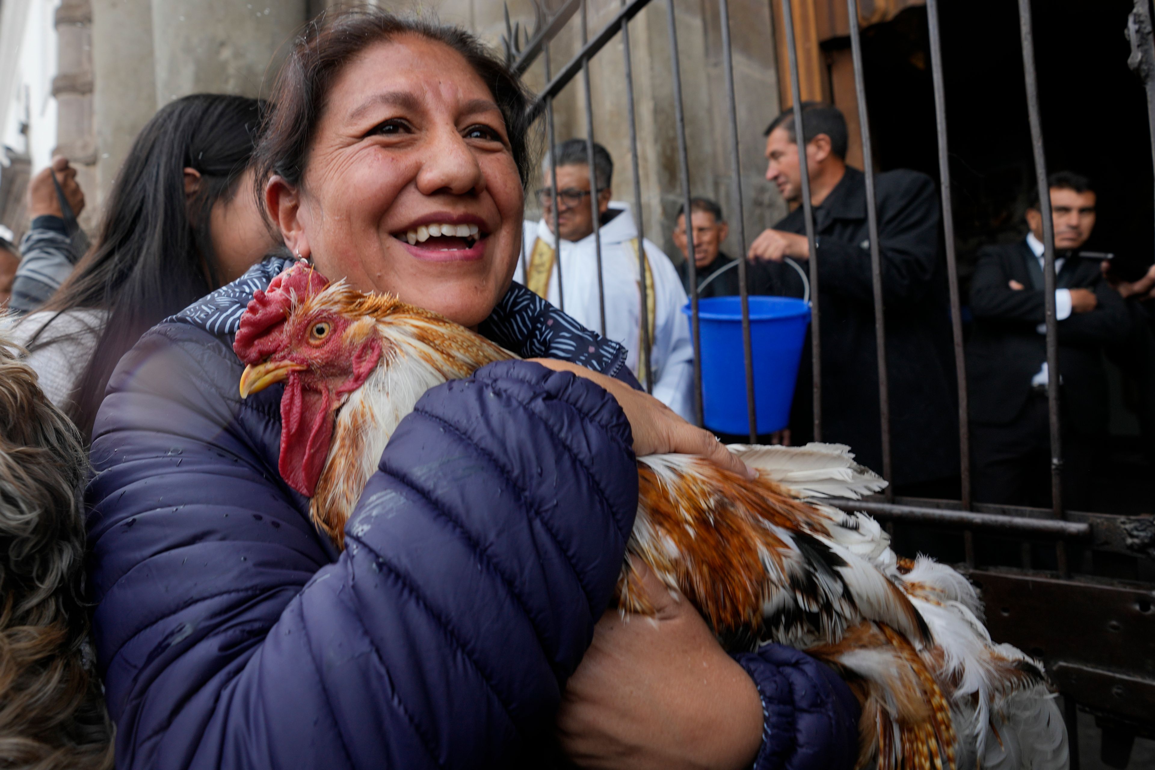 Pucho and its caretake are sprinkled with holy water during a Blessing of the Animals service at San Francisco Church in Quito, Ecuador, Friday, Oct. 4, 2024, the feast day of St. Francis of Assisi. (AP Photo/Dolores Ochoa)