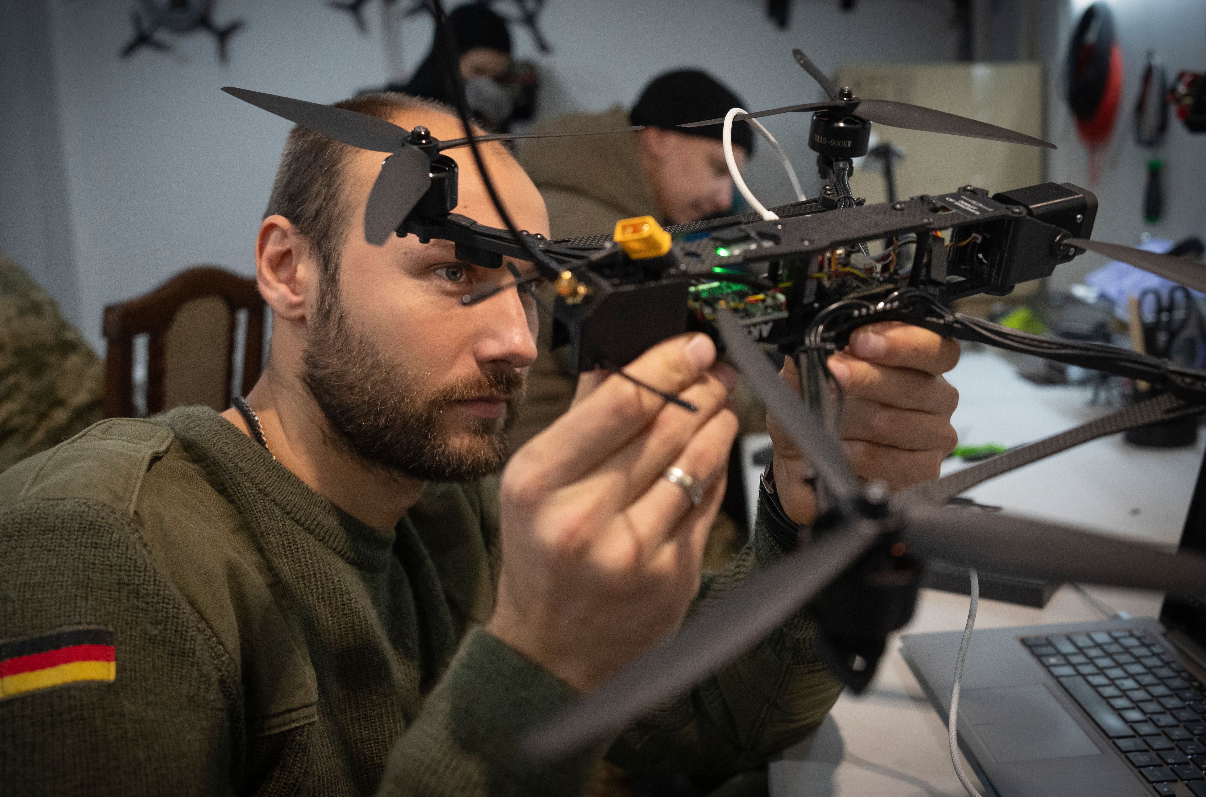 A soldier of Ukraine's Khartia brigade, callsign Tolstiy, inspects a FPV drone in a drone repair workshop close to the front line in the Kharkiv region, Ukraine, Thursday, Nov. 7, 2024. (AP Photo/Efrem Lukatsky)