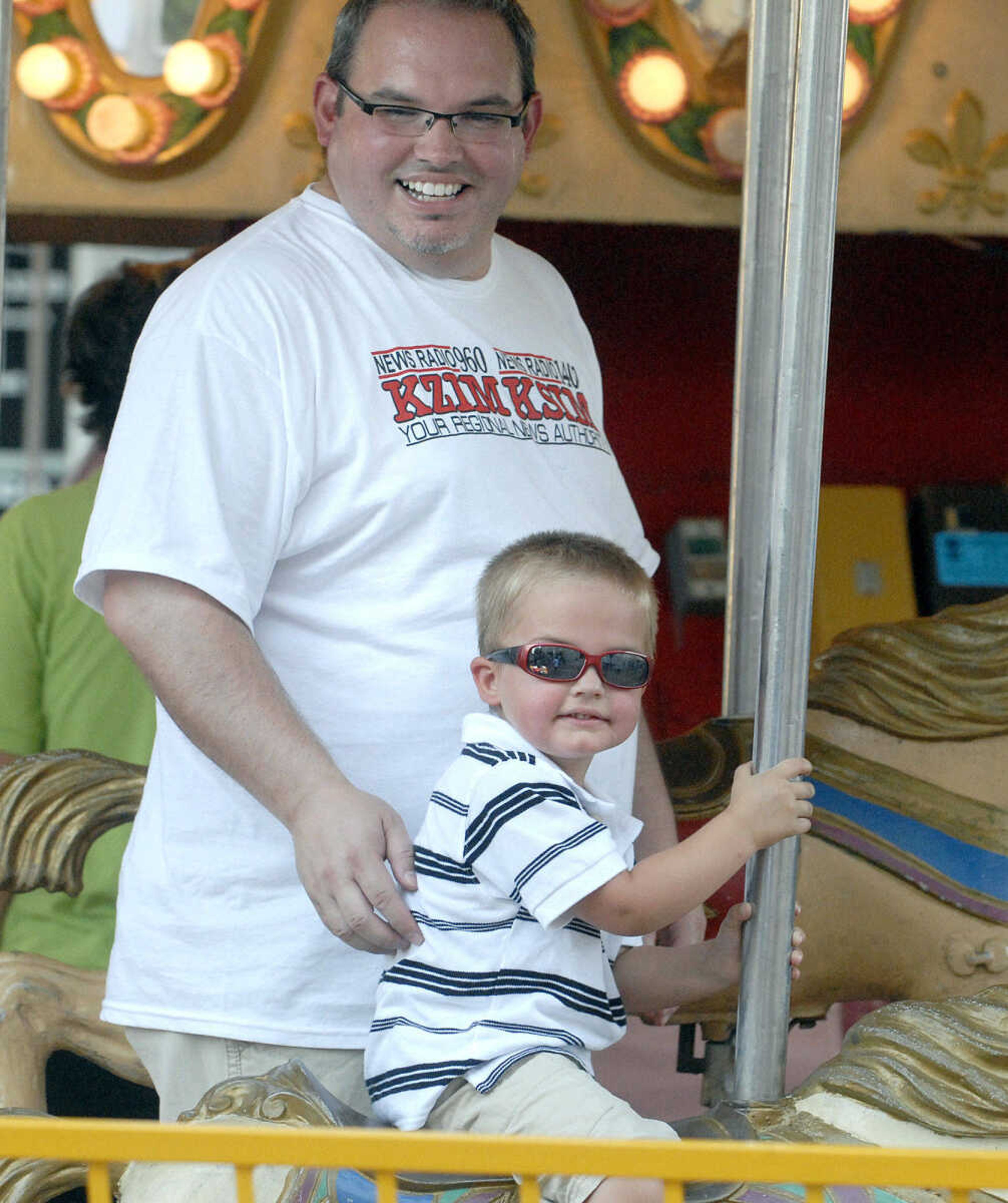 LAURA SIMON ~ lsimon@semissourian.com
Roger Price and his three-year-old son Jack ride the carousel Tuesday, July 26, 2011 during the 103rd annual Jackson Homecomers celebration.