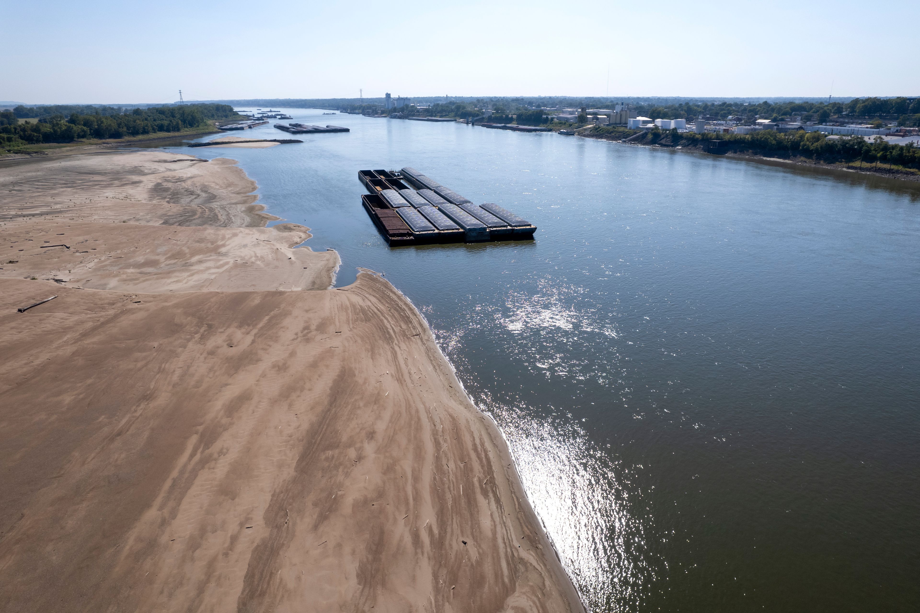 FILE - Barges float in the Mississippi River as a portion of the riverbed is exposed, Sept. 15, 2023, in St. Louis. (AP Photo/Jeff Roberson, File)