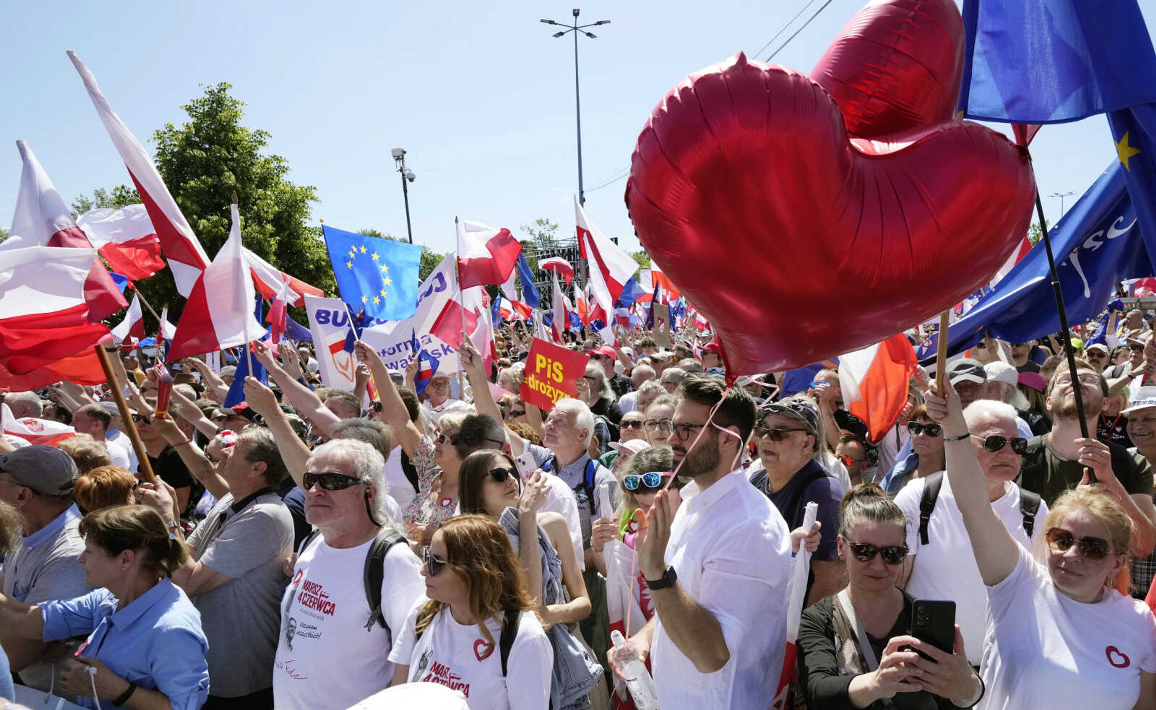 Participants join an anti-government march led by the centrist opposition party leader Donald Tusk, who along with other critics accuses the government of eroding democracy, on Sunday in Warsaw, Poland. Poland's largest opposition party led a march Sunday meant to mobilize voters against the right-wing government, which it accuses of eroding democracy and following Hungary and Turkey down the path to autocracy. The march is being held on the 34th anniversary of the first partly free elections, a democratic breakthrough in the toppling of communism across Eastern Europe.