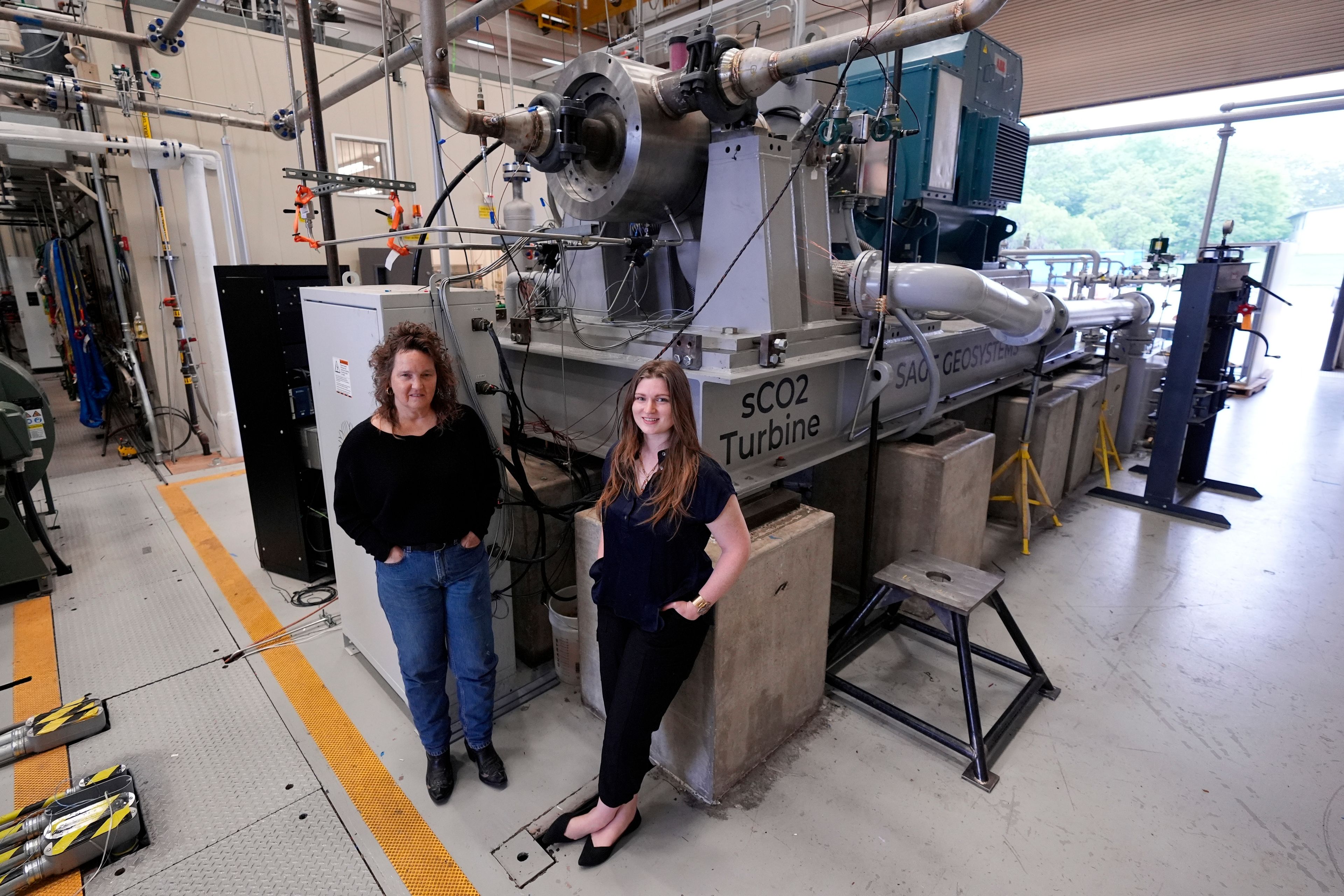 Cindy Taff, left, and Brianna Byrd with Sage Geosystems, a startup that aims to make clean electricity, visit Southwest Research Institute where testing and research is taking place in San Antonio, Monday, April 1, 2024. (AP Photo/Eric Gay)