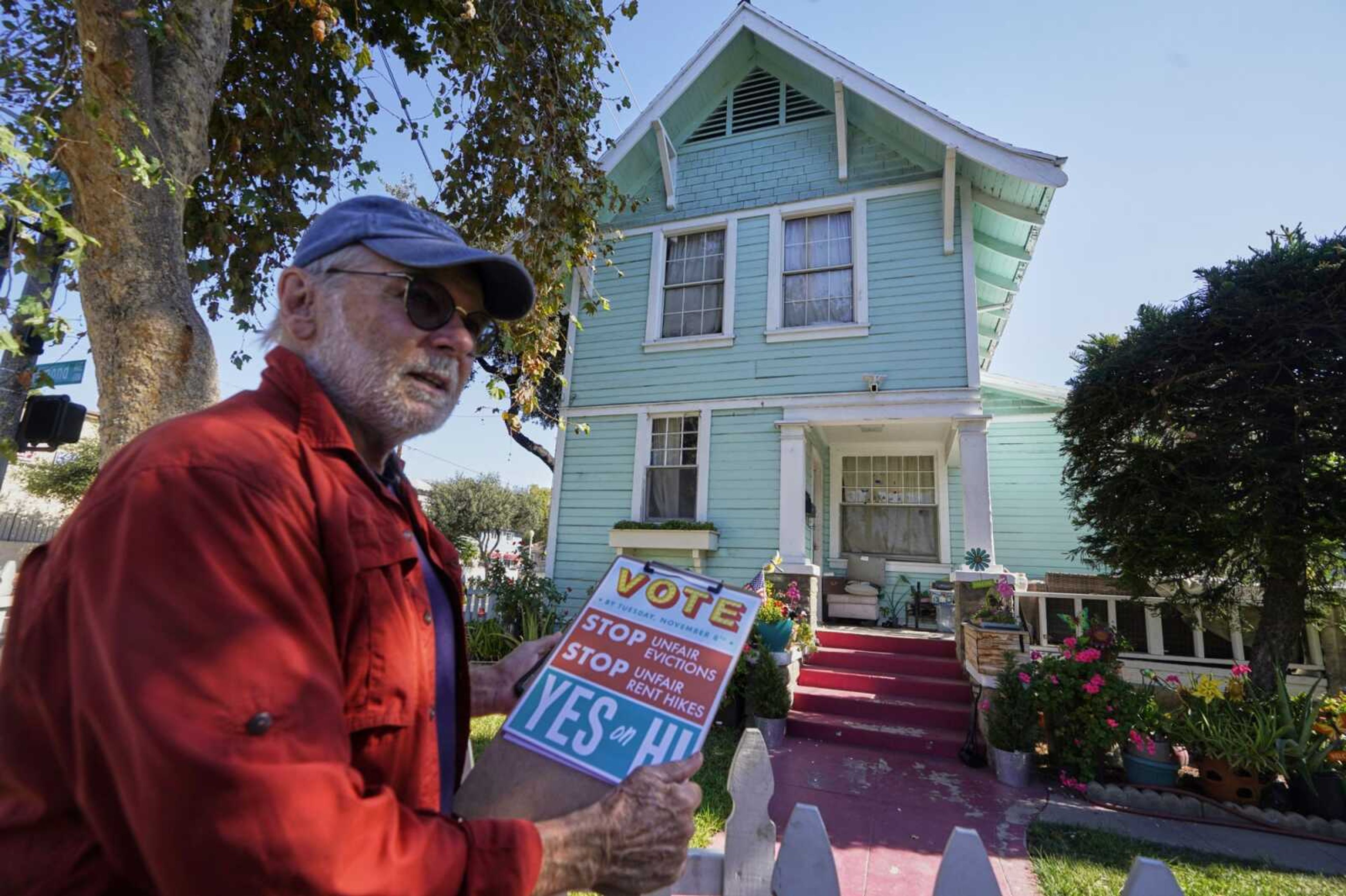 Yes on Measure H! volunteer Ed Washatka canvases the neighborhood Saturday in Pasadena, California. Cities across the country are pushing measures to stabilize or control rents when housing prices are skyrocketing. Voters from Orange County, Florida, and in several California cities are asking voters to approve ballot measures that would cap rent increases.