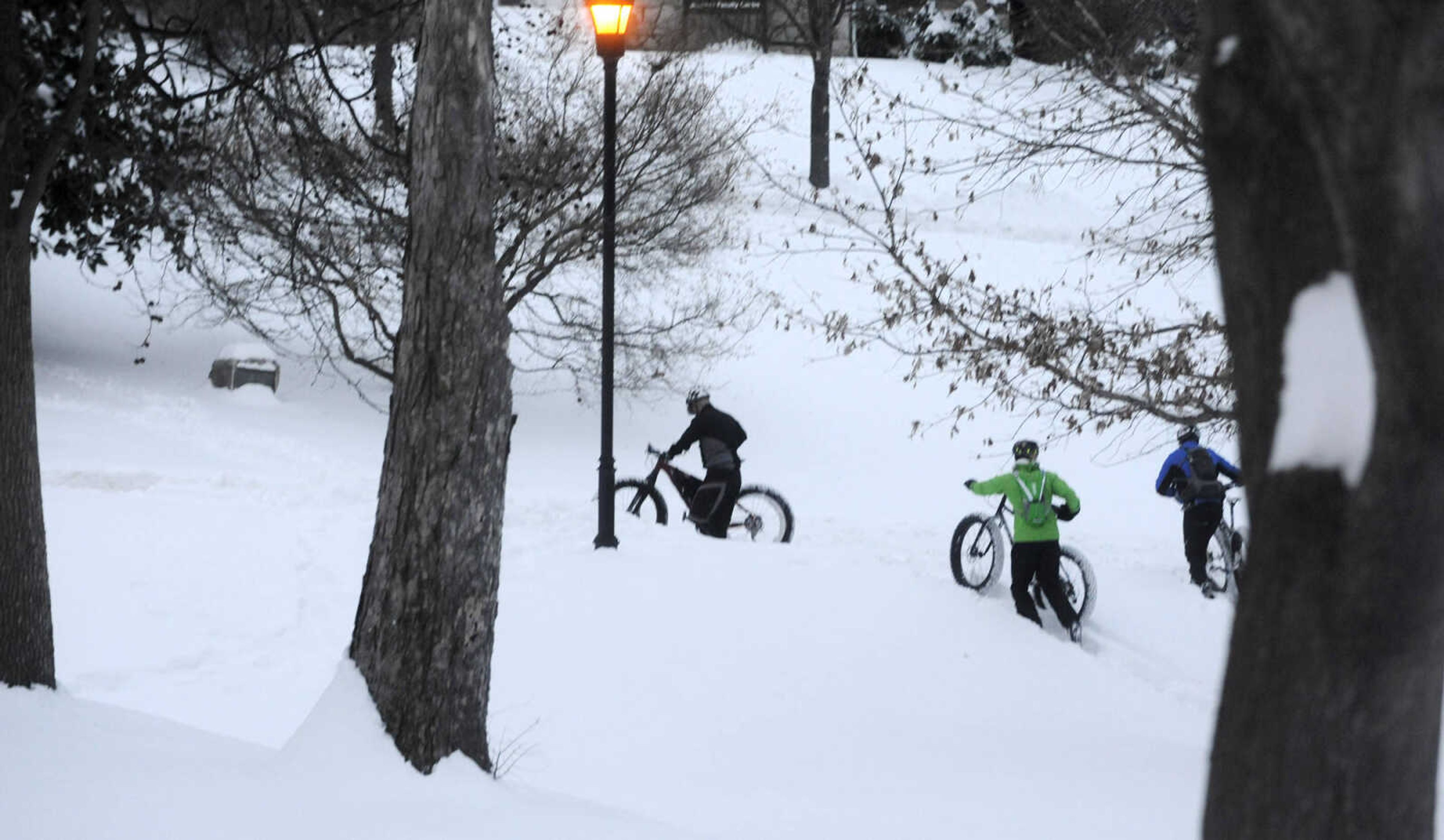 LAURA SIMON ~ lsimon@semissourian.com

Bob Berck, left, Tim Vollink, center, and John Dodd ride fat bikes through the snow on the terraces outside Academic Hall Tuesday evening, Feb. 17, 2015.