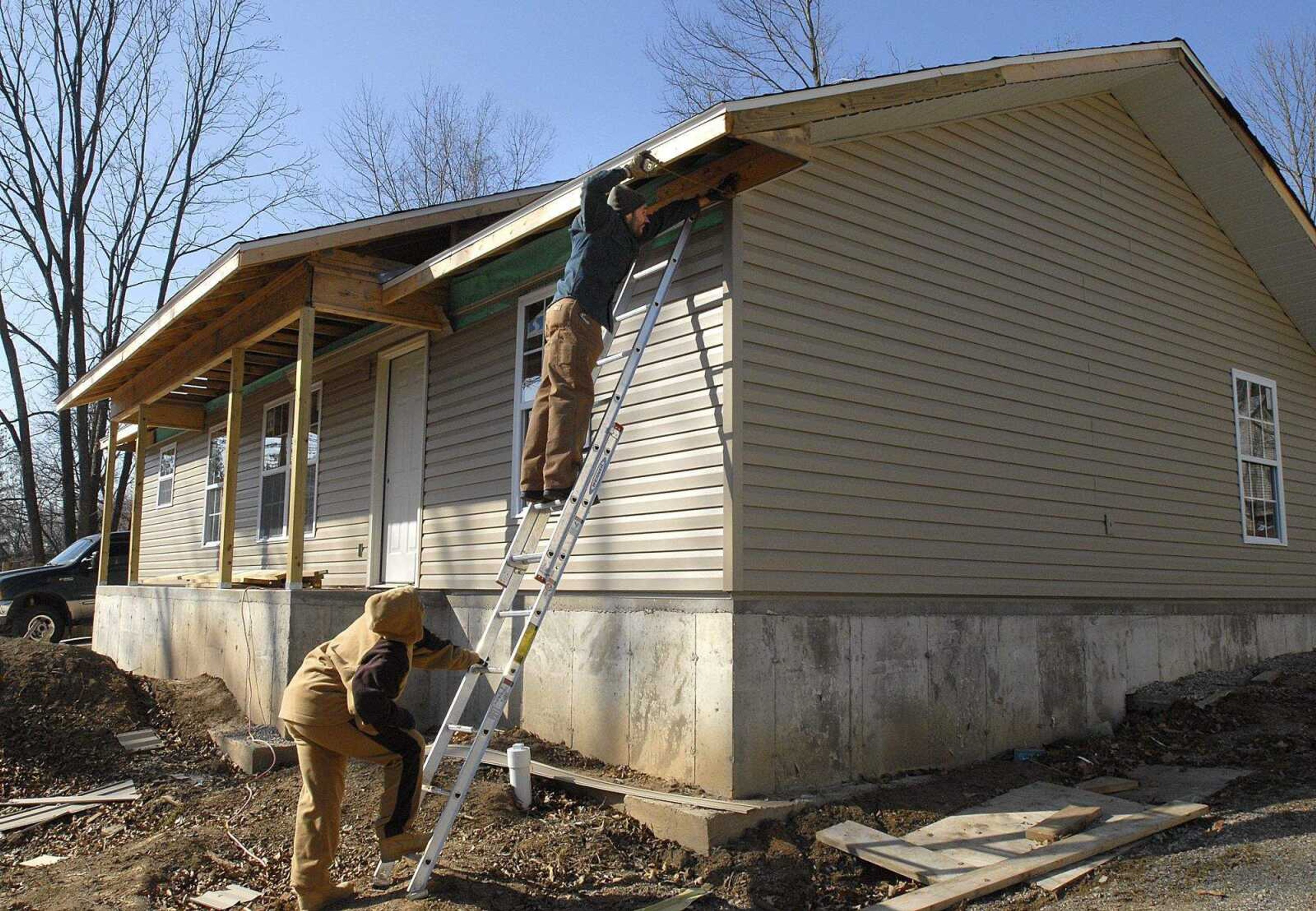 FRED LYNCH ~ flynch@semissourian.com
Tia Murray holds the ladder for Neil Randol outside a Habitat for Humanity house Saturday in Cape Girardeau.