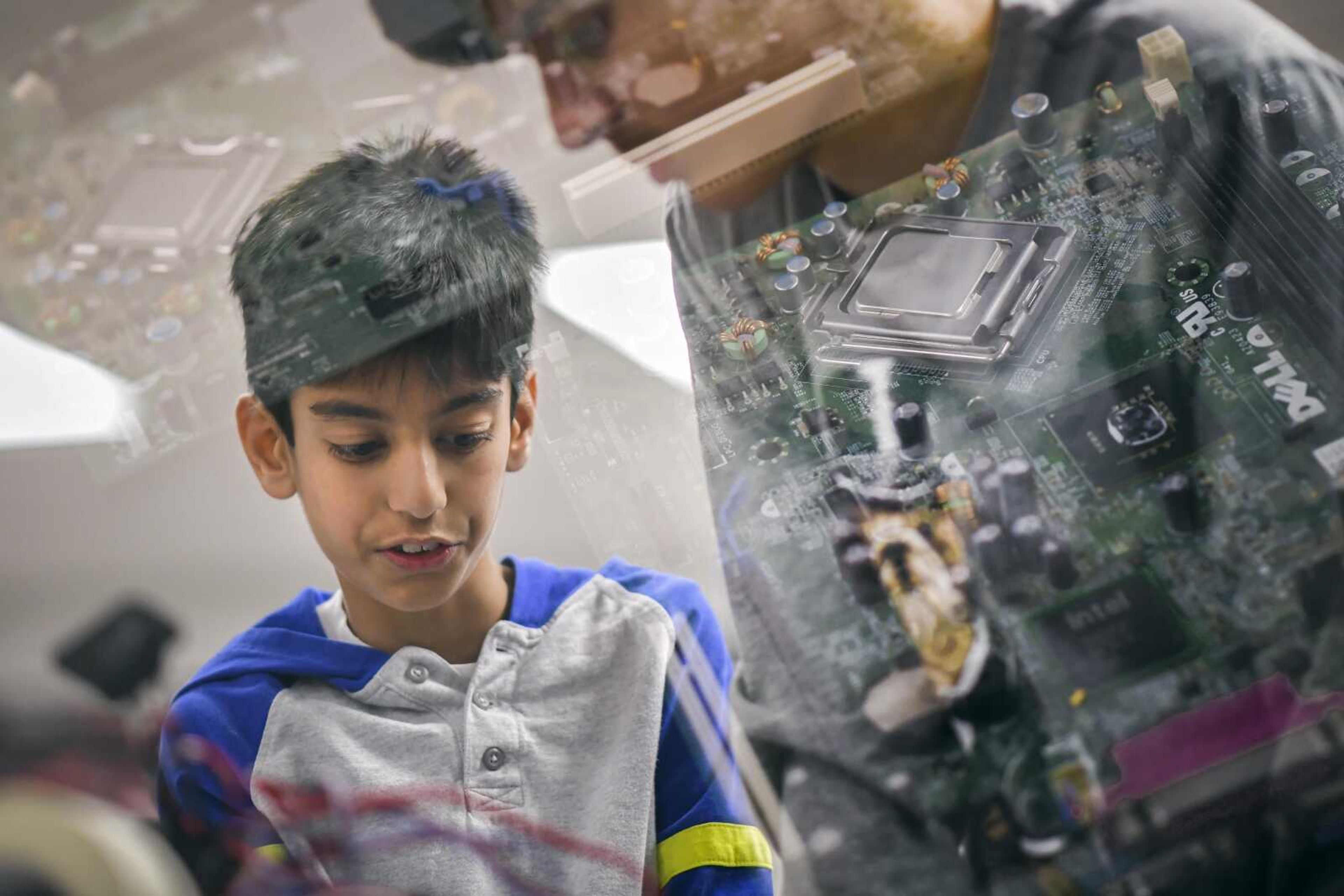 Robotics club member Dulina Dias, 12, works on a robot during a robotics club meeting in this in-camera double exposure photograph, which also shows portions of a circuitboard, on Jan. 16 at Terry W. Kitchen Central Junior High School in Cape Girardeau.