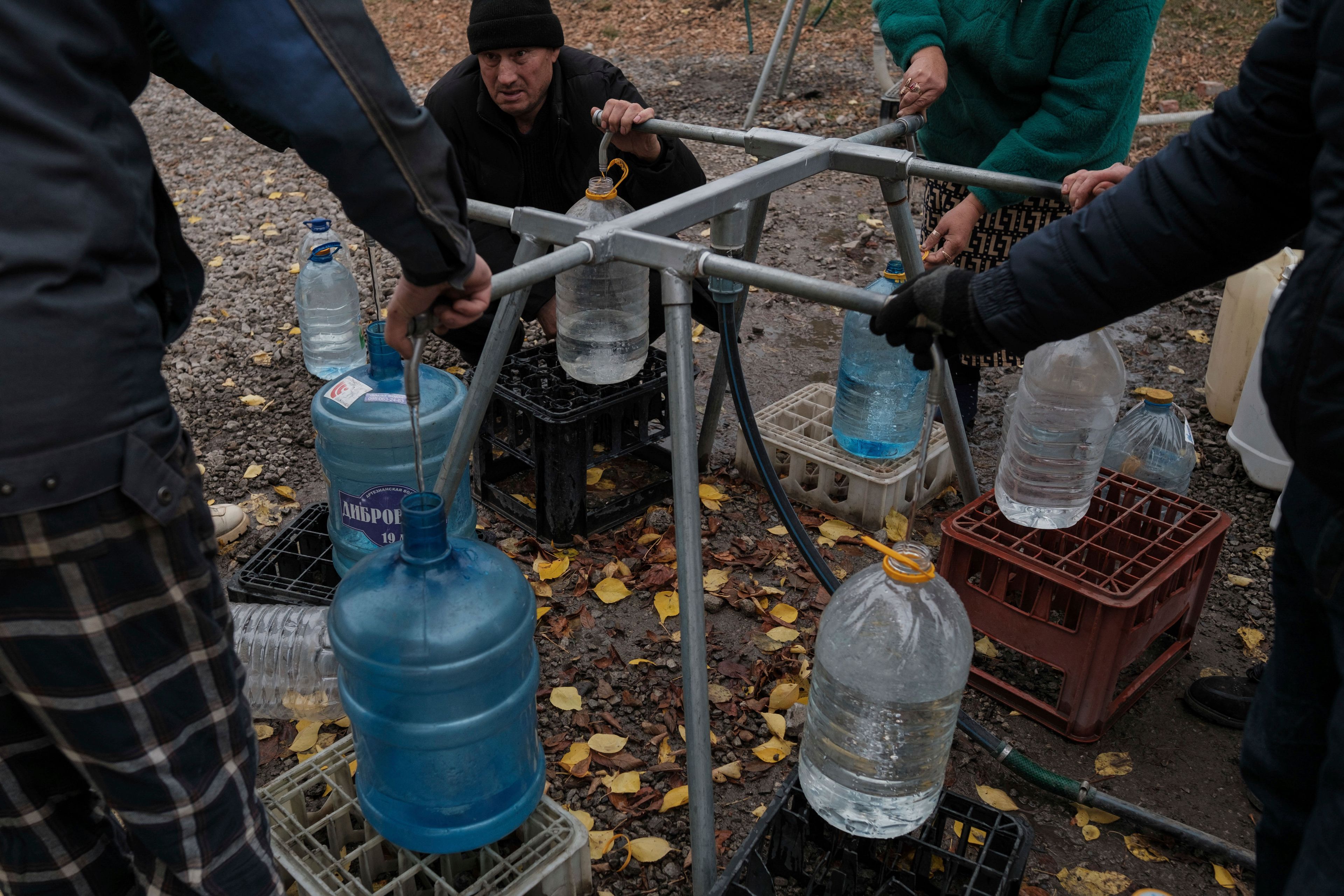 Residents collect water in bottles because the constant Russian shelling has left civilians without functioning infrastructure facilities in Pokrovsk, Nov. 11, 2024 (George Ivanchenko/AP)