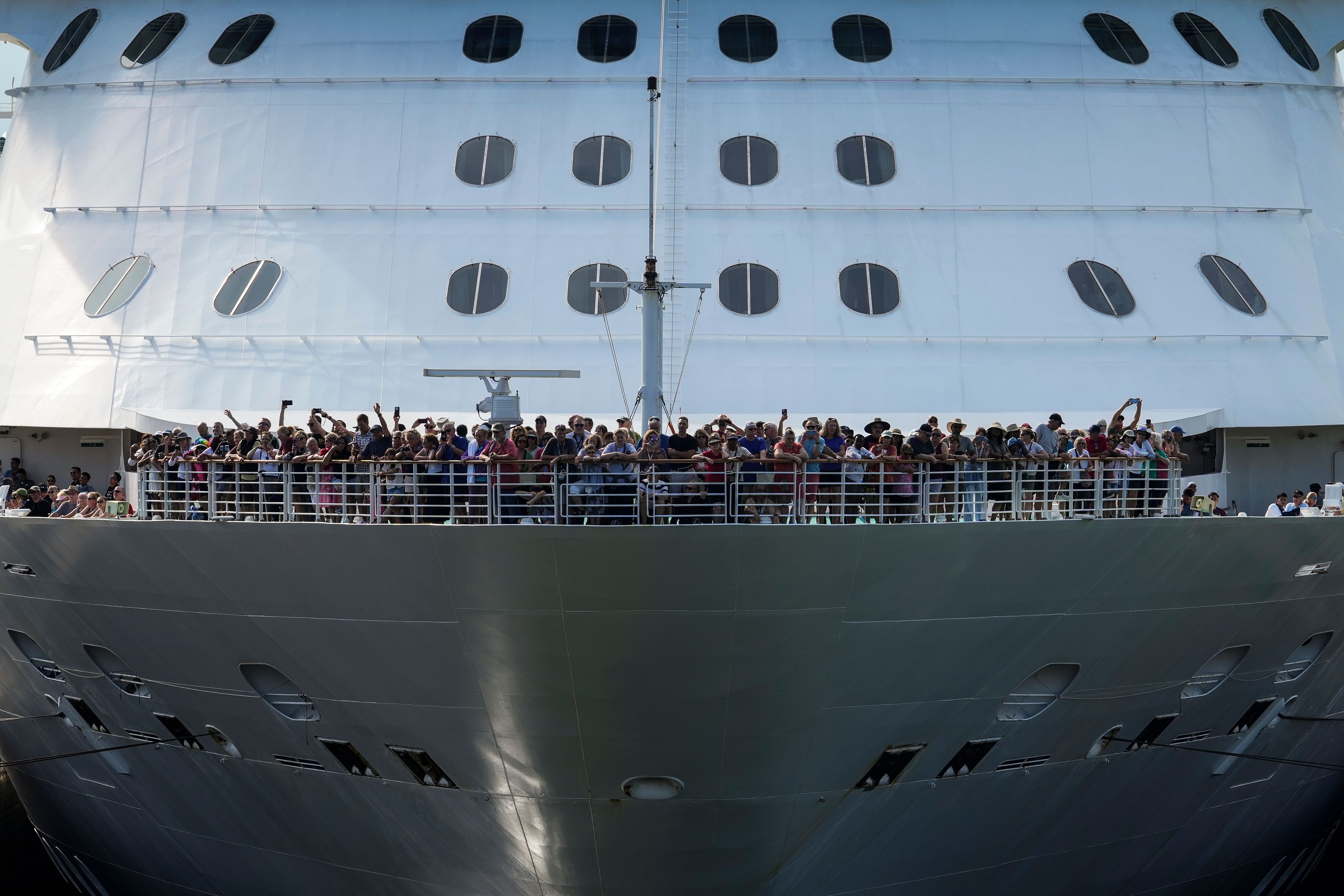 Passengers stand on the forward of the Brilliance of the Seas cruise ship as the vessel approaches the gates of Miraflores Locks to become the first cruiser of the season to pass through the Panama Canal in Panama City, Monday, Oct. 7, 2024. (AP Photo/Matias Delacroix)