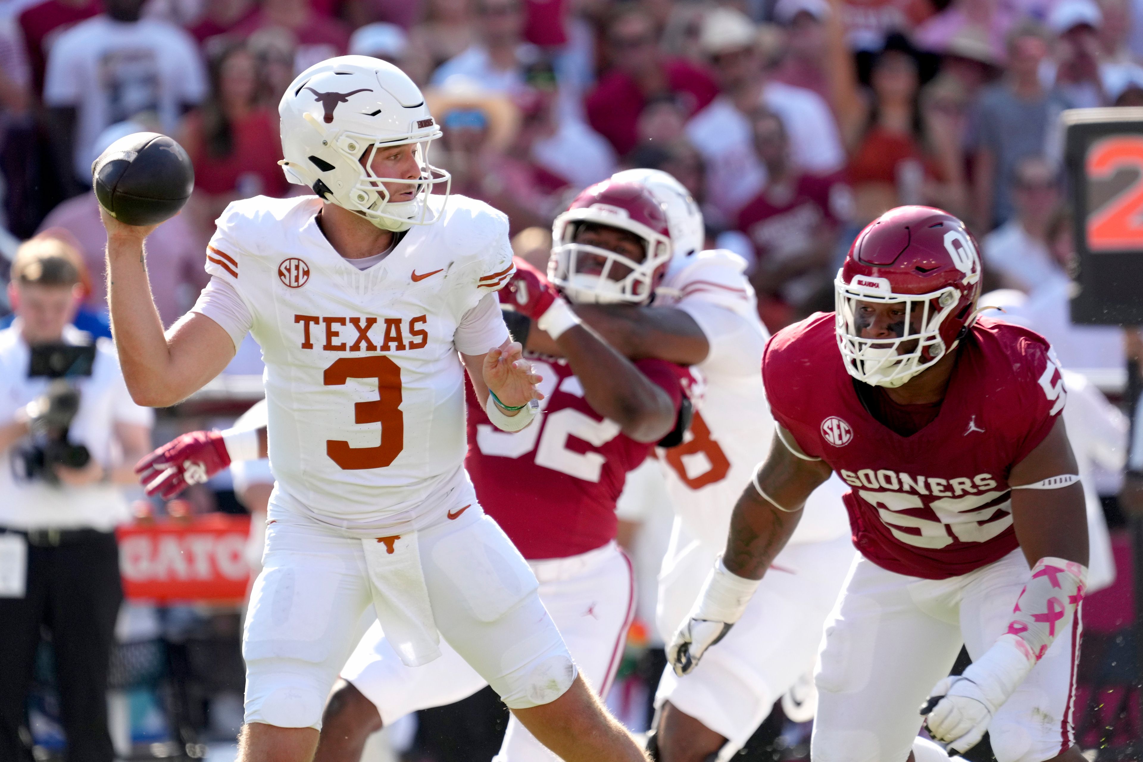 Texas quarterback Quinn Ewers (3) throws a pass as Oklahoma defensive lineman Gracen Halton (56) rushes in the first half of an NCAA college football game in Dallas, Saturday, Oct. 12, 2024. (AP Photo/Jeffrey McWhorter)