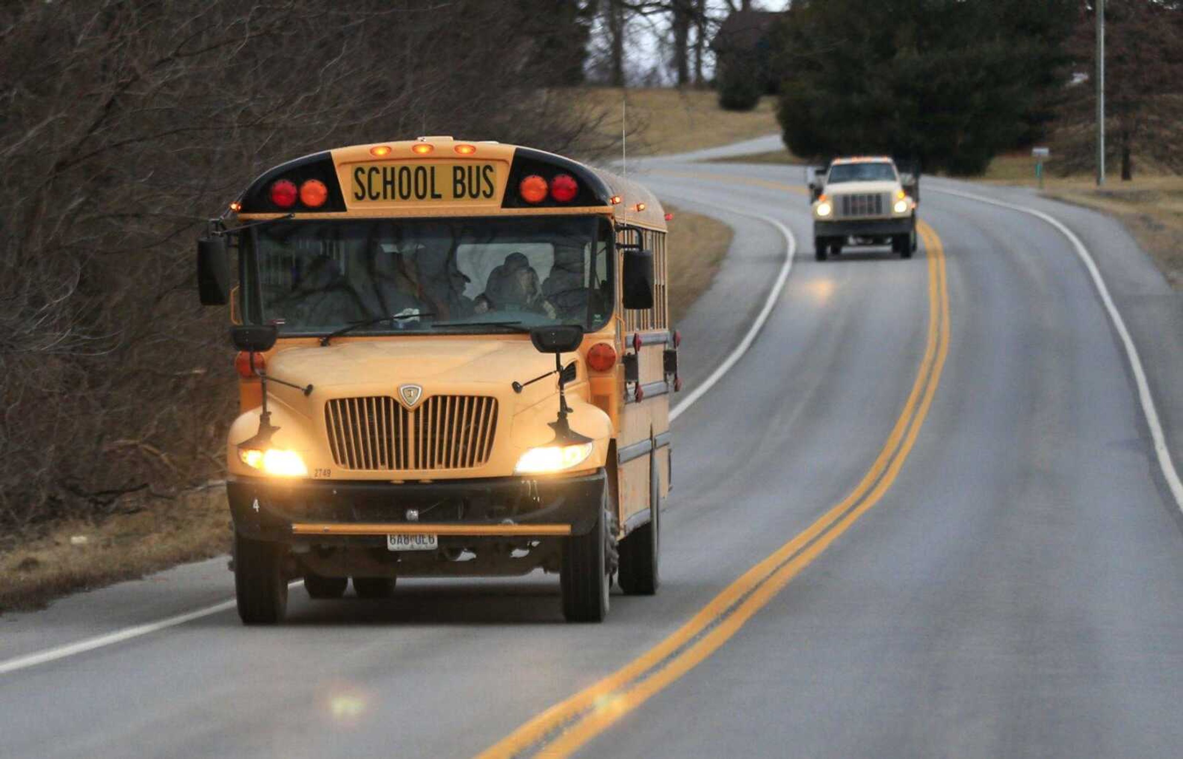 A West Platte School District bus drives Wednesday along Route 45 near Weston, Missouri. Missouri Gov. Eric Greitens said his budget plan won't take a "single penny" out of K-12 classrooms. But a 34 percent reduction in transportation funding might keep school districts across the state from hiring new staff or buying new textbooks and technology.