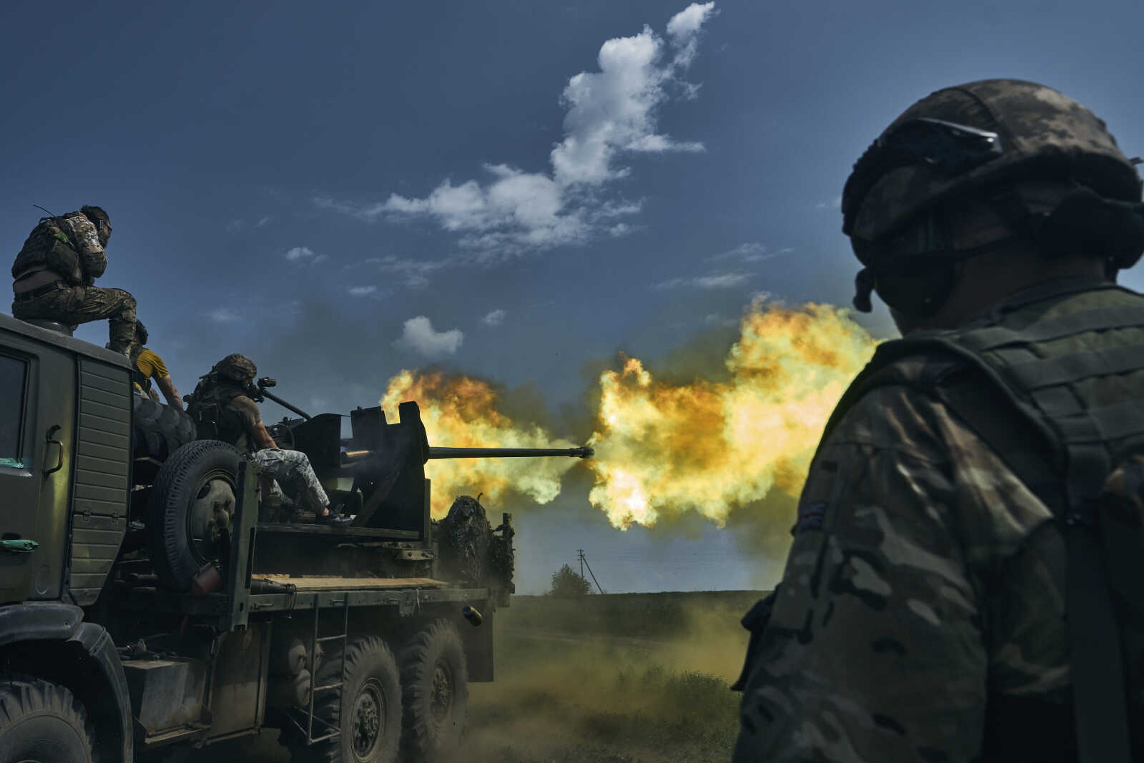 Ukrainian soldiers fire a cannon Monday near Bakhmut, an eastern city where fierce battles against Russian forces have been taking place, in the Donetsk region, Ukraine.