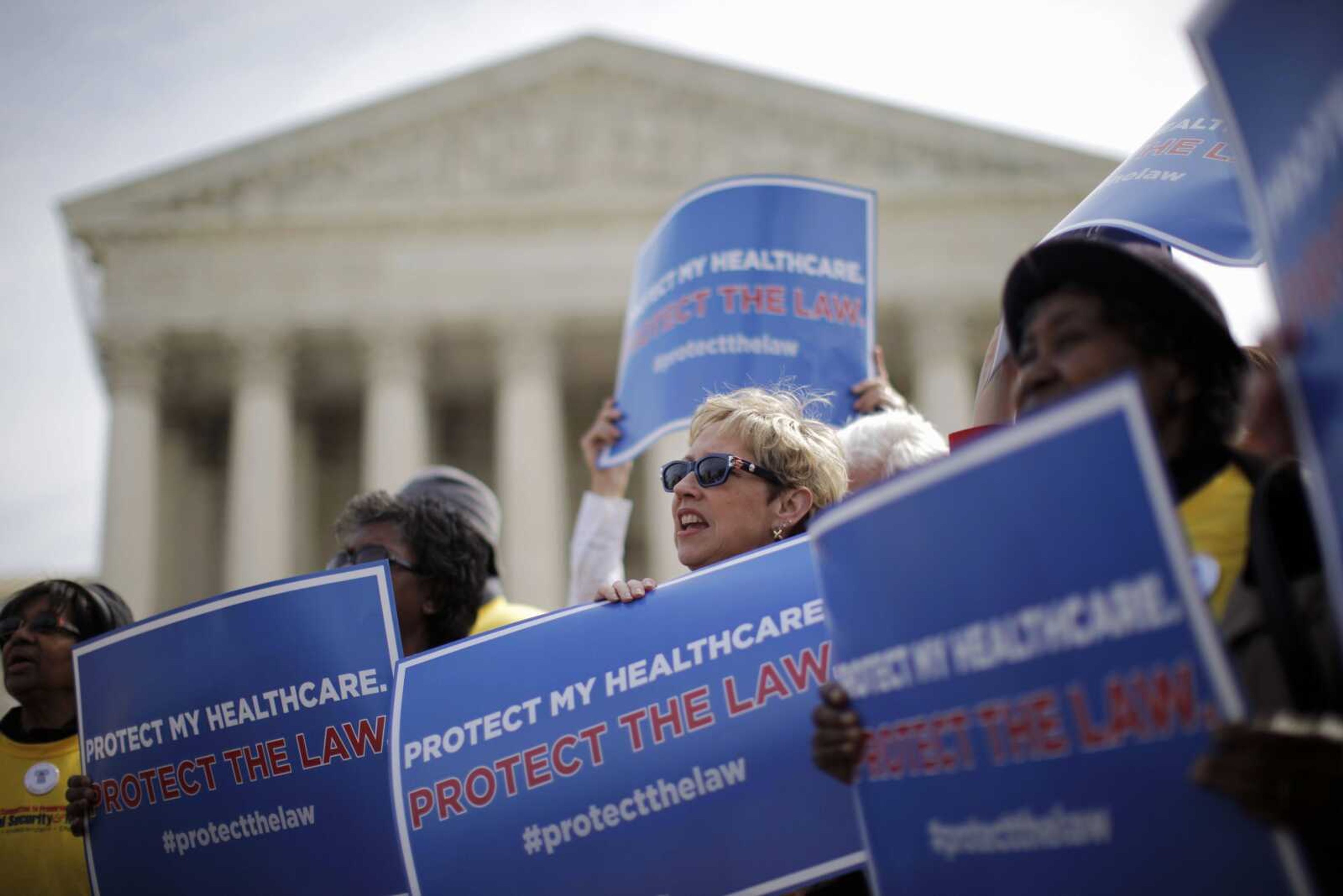 Supporters of health care reform rally in March 2012 in front of the Supreme Court in Washington on the final day of arguments regarding the health care law signed by President Barack Obama. The Supreme Court agreed Friday to hear a new challenge to President Barack Obama's health care law. The justices said they will decide whether the law authorizes subsidies that help millions of low- and middle-income people afford their health insurance premiums.  (AP Photo/Charles Dharapak, File)