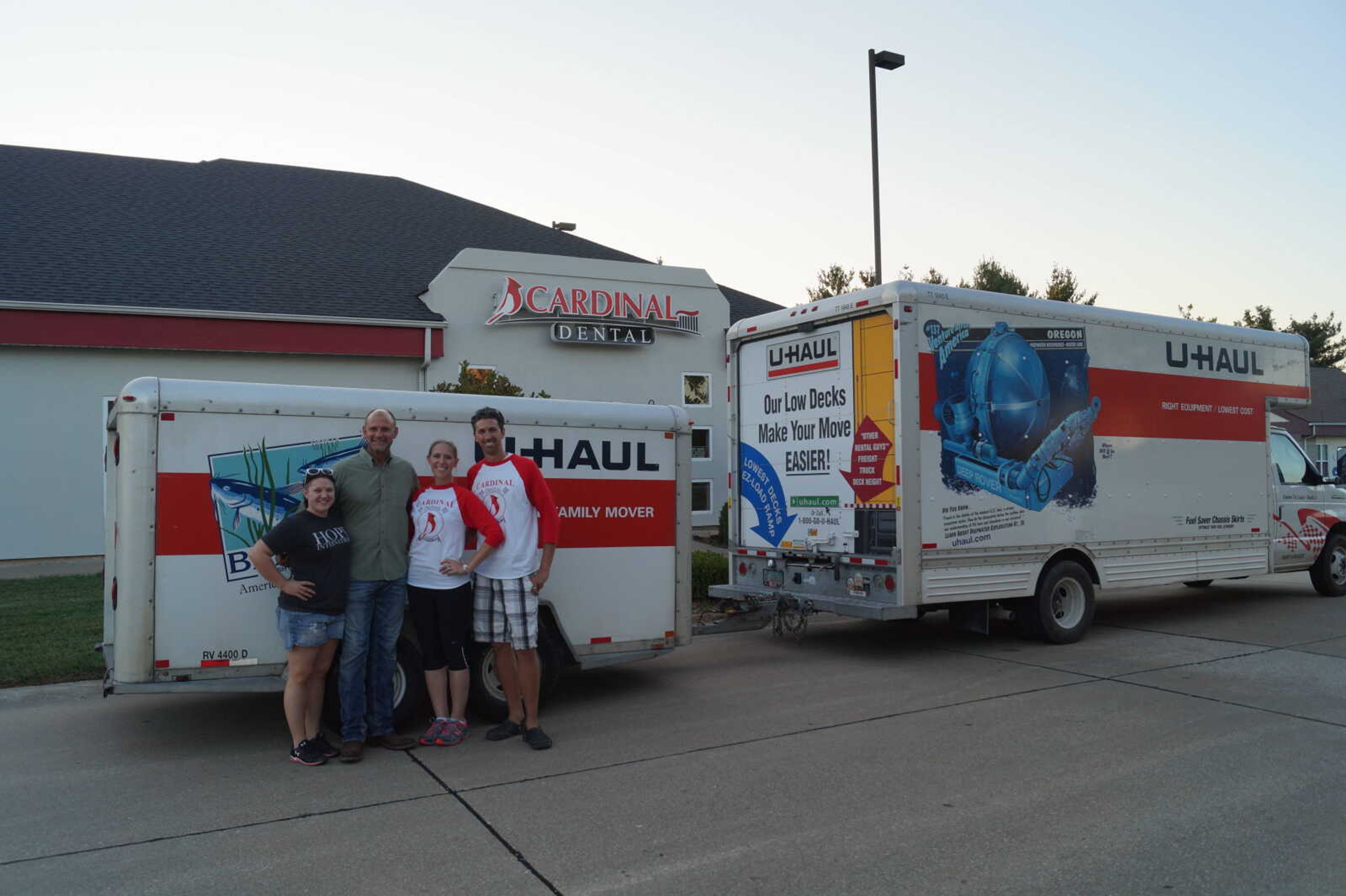 Pastor Tim Russell and his daughter of Smiles of Hope stand with Cynthia Ulrich-Blalock, DDS and her husband Richard Blalock, DC in front of the Uhaul trucks full of dental equipment.  Dr. Ulrich-Blalock donated over $42,000 worth of dental equipment to the charity.