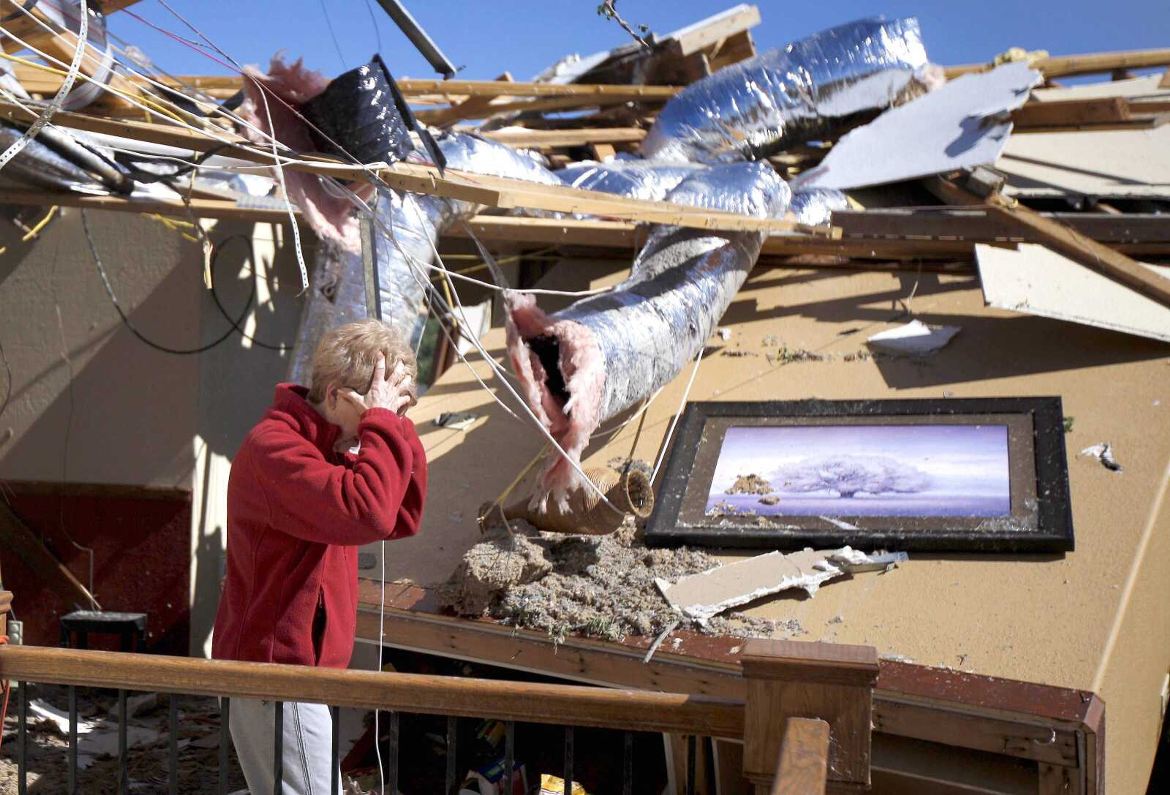 Carole Beckett reacts as she sorts through belongings at her home Sunday after a tornado moved through Woodward, Okla. (Bryan Terry ~ The Oklahoman)