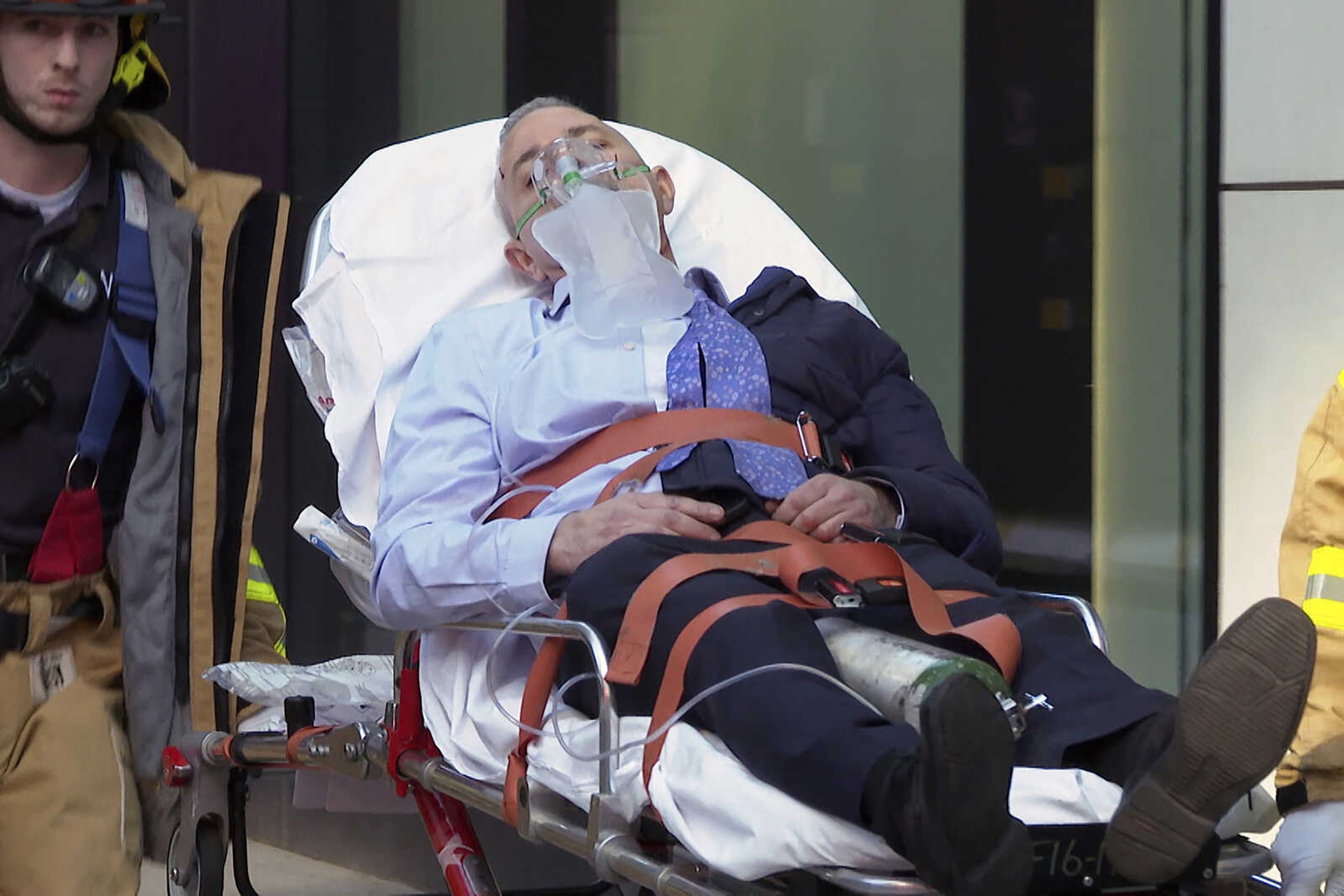 New York City Fire Department personnel stretcher a person away from an area Tuesday in New York, following the partially collapsed of a parking garage.