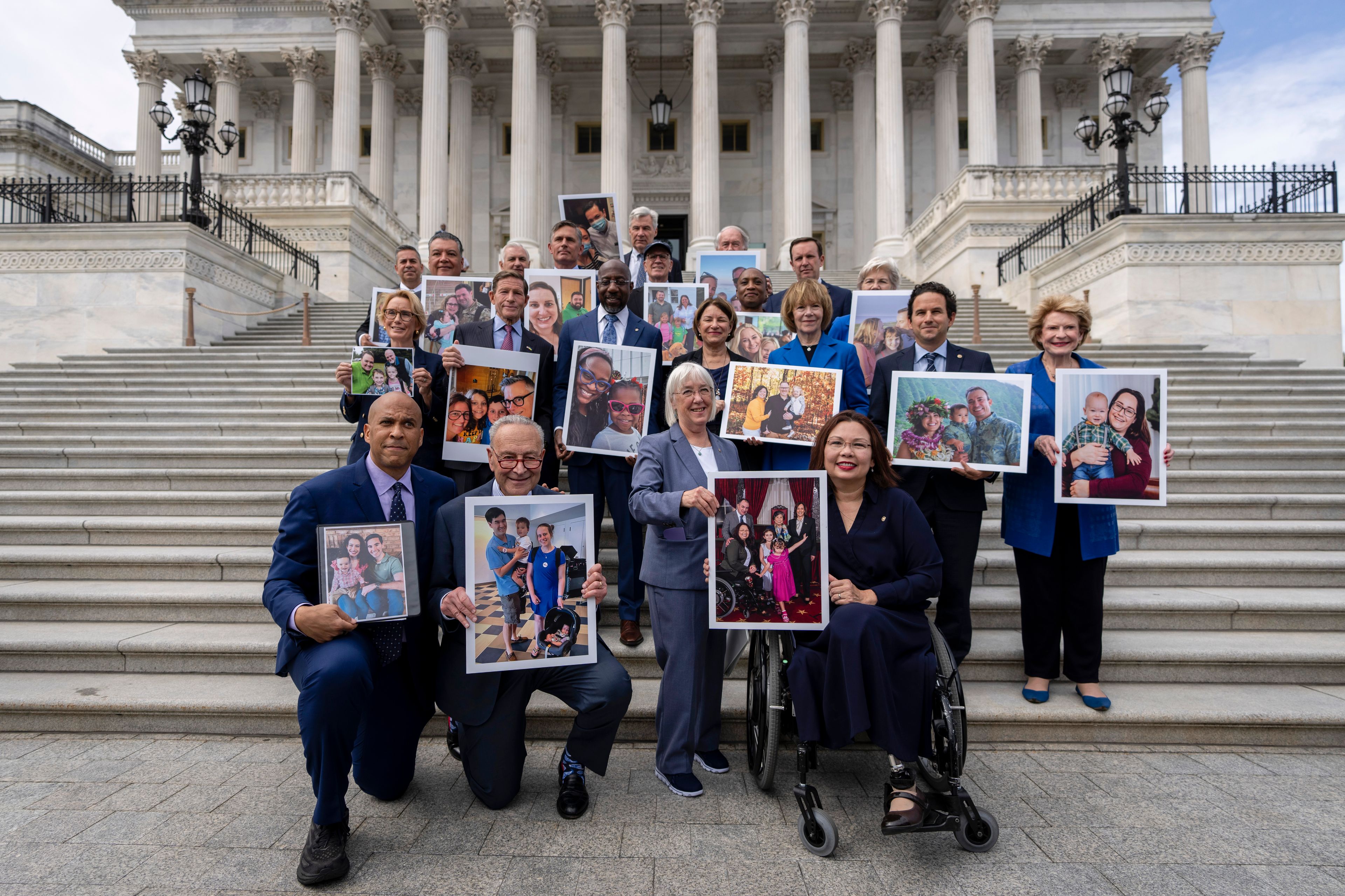 Front row, left to right, Sen. Cory Booker, D-NJ., Senate Majority Leader Chuck Schumer, D-NY, Sen. Patty Murray, D-Wash., and Sen. Tammy Duckworth, D-Ill., pose for a photograph after speaking about the need to protect rights to in vitro fertilization (IVF), on the Senate steps at the Capitol in Washington, Tuesday, Sept. 17, 2024. (AP Photo/Ben Curtis)