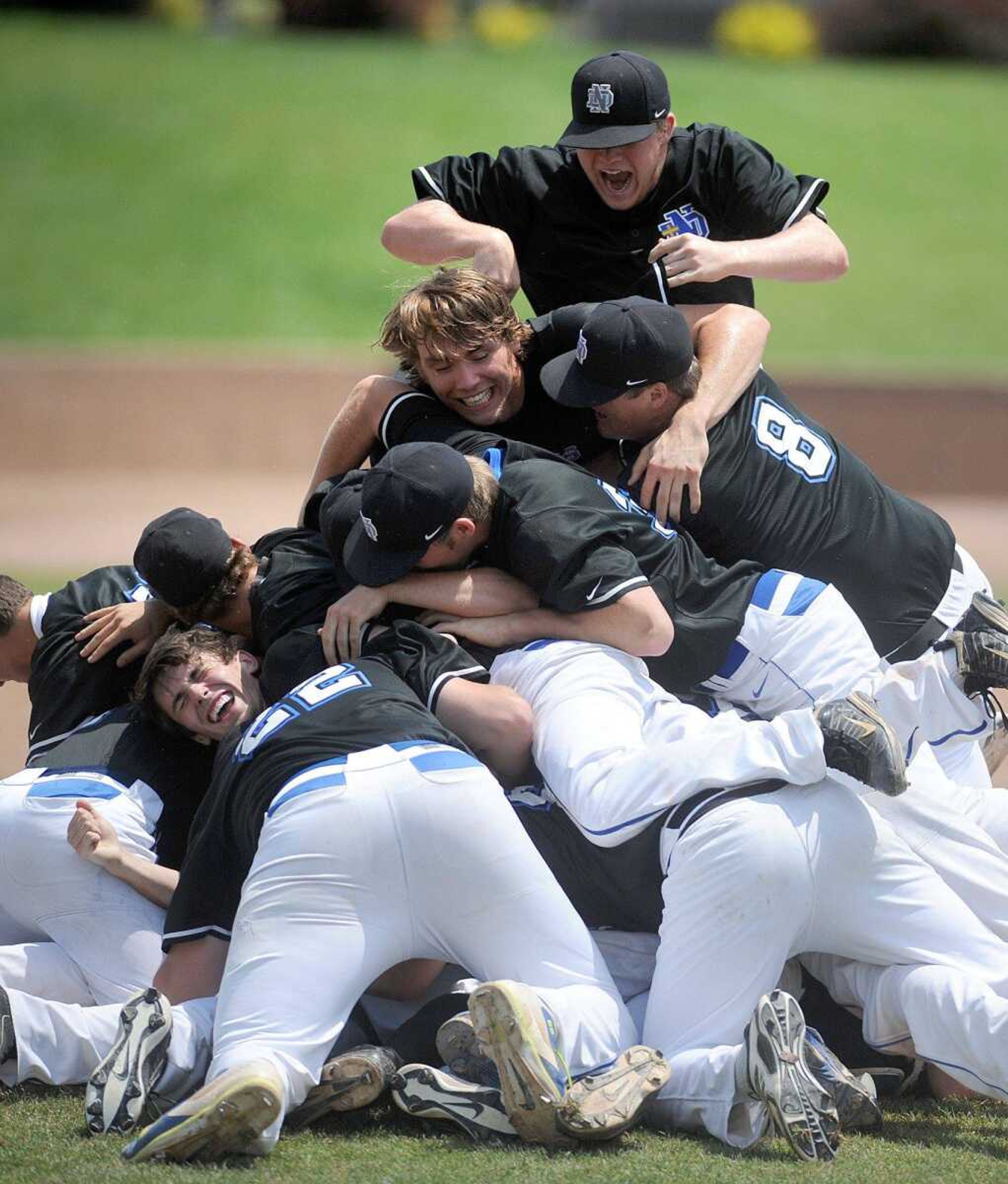 Notre Dame players dogpile after defeating Sullivan 17-0 in the Class 4 championship Saturday at T.R. Hughes Ballpark in O'Fallon, Missouri. (Laura Simon)