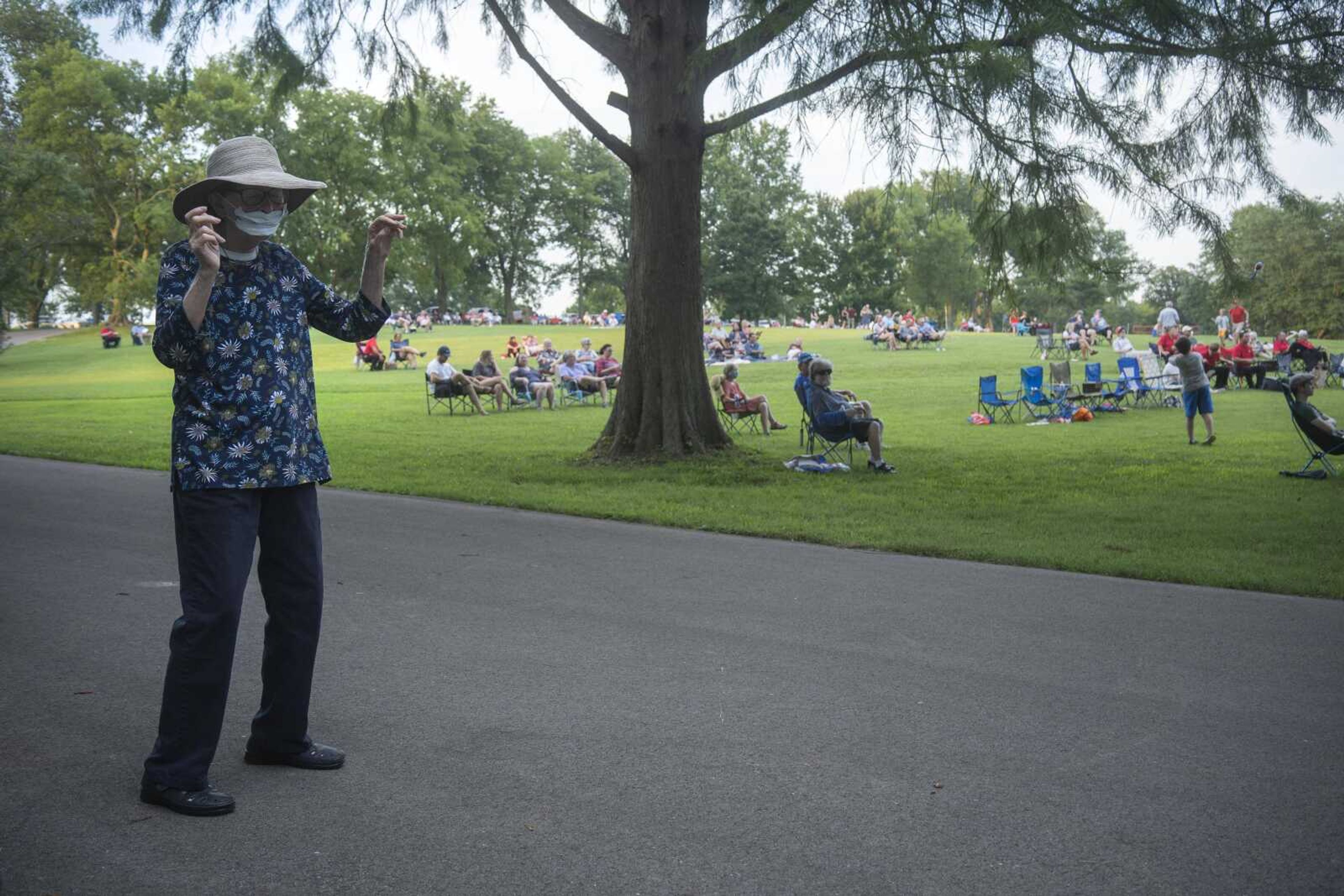 Mary, who declined to provide her last name for publication, dances while wearing a mask and standing at a distance from other attendees during an Independence Day celebration at the Jackson Municipal Band Shell.