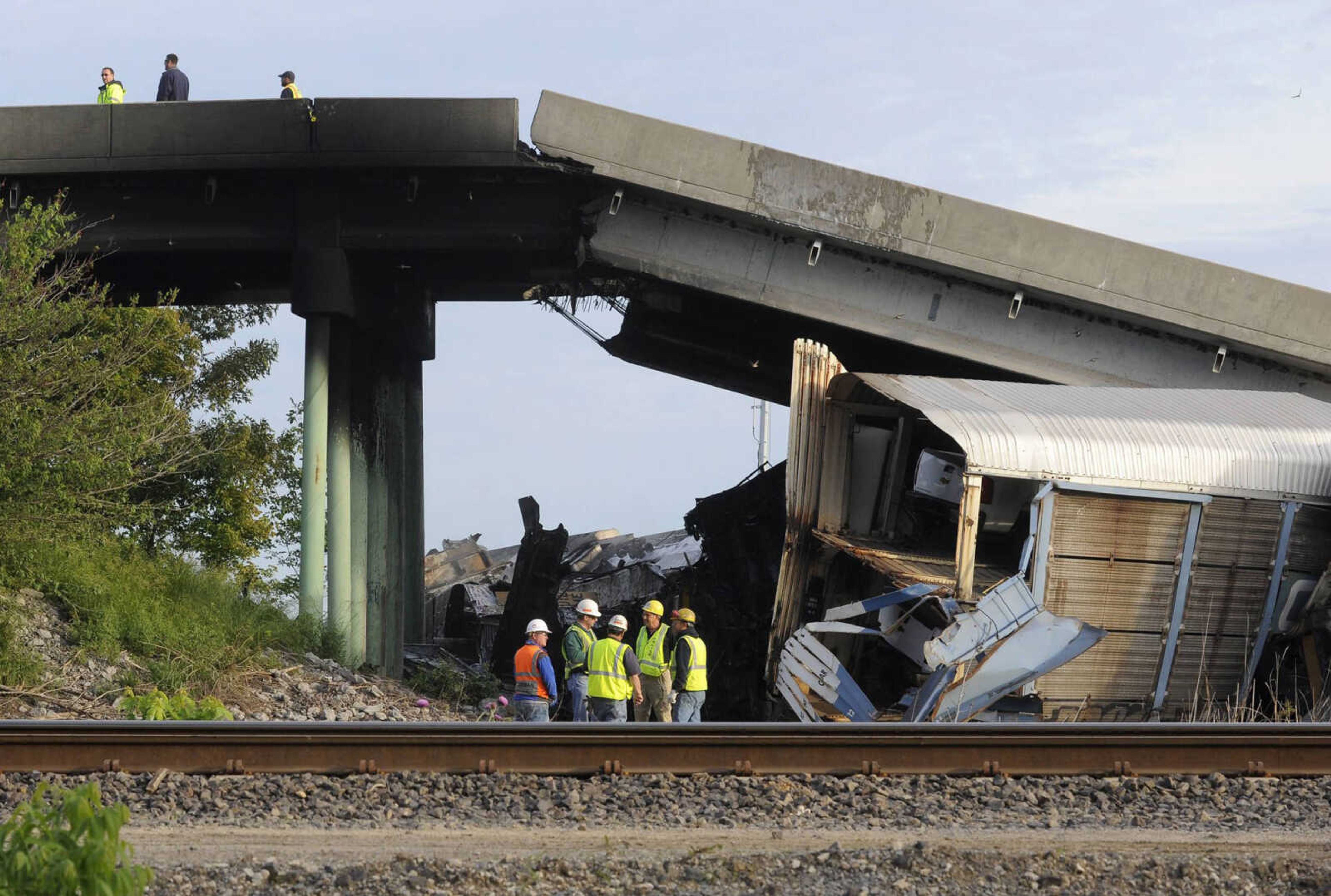 The Route M overpass at Rockview, Missouri collapsed May 25, 2013, after a Union Pacific train struck a Burlington Northern Santa Fe train, derailing several rail cars and knocking down one of the bridge's support pillars. (Fred Lynch)