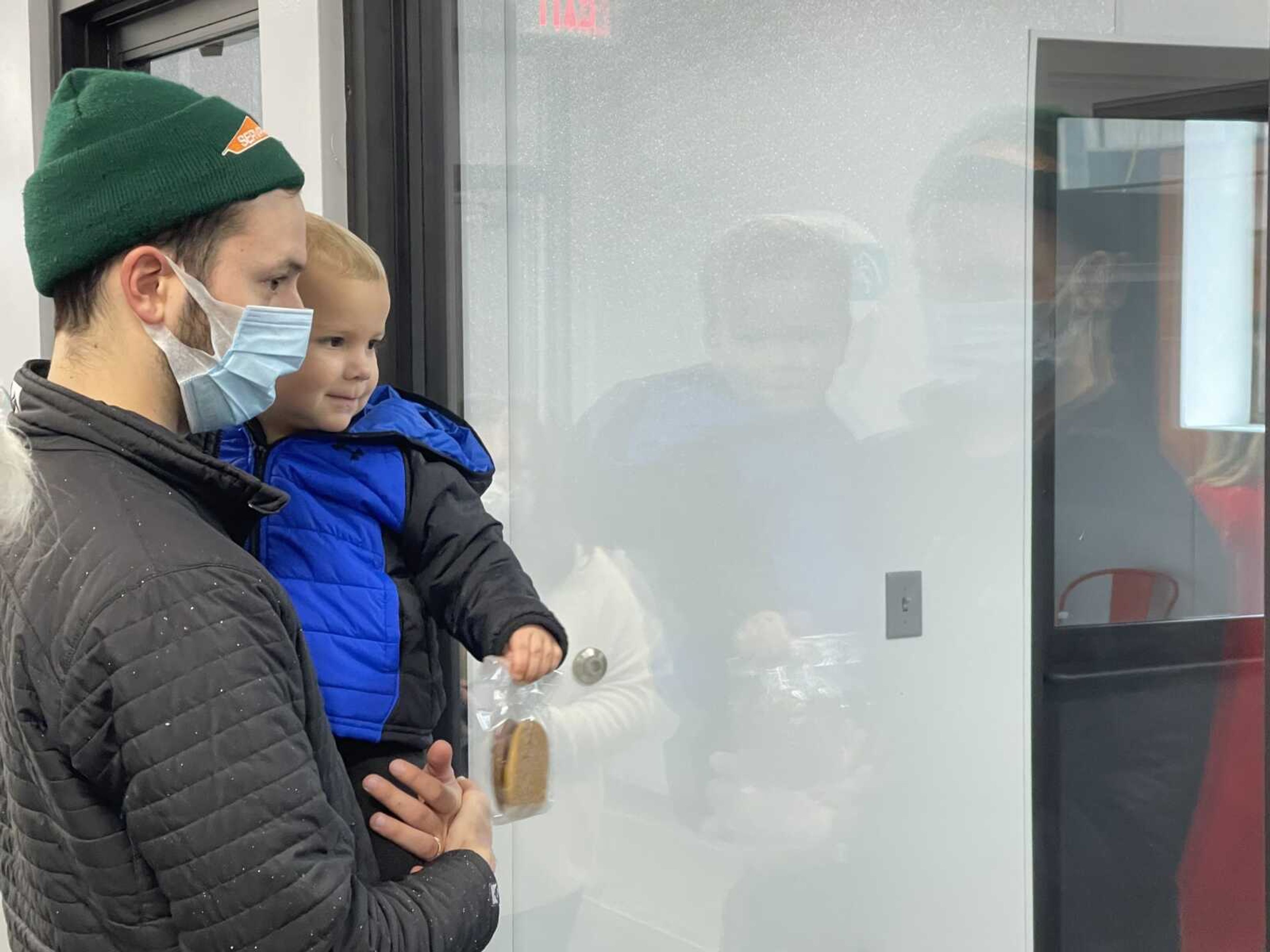 Mac Davenport and his son, Benjamin, look at adoptable puppies at Southeast Missouri Pets in Cape Girardeau on Thursday. The organization's new facility allows for grouping animals by age and/or type.