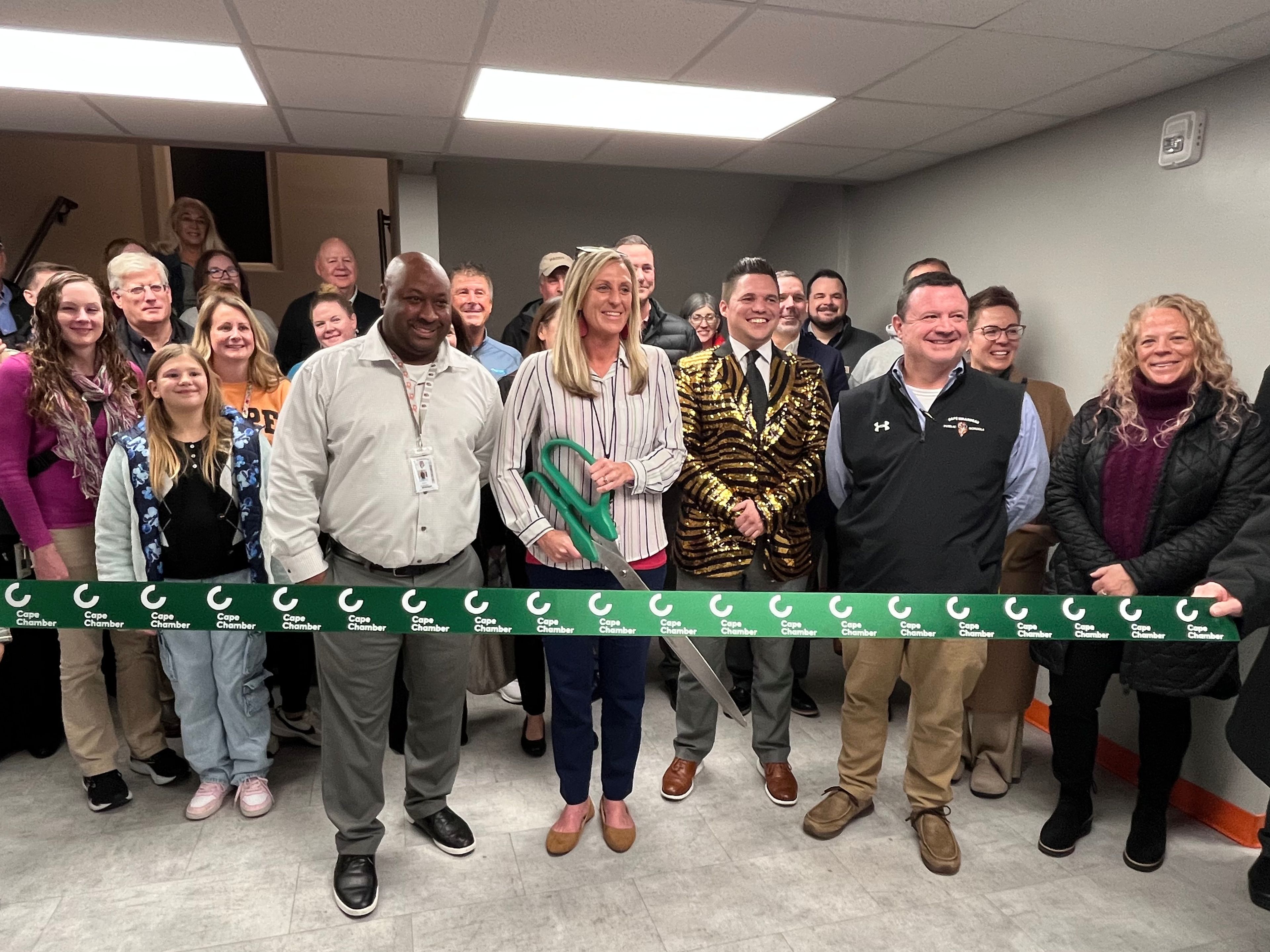 Cape Central Academy director Andrea Beggs prepares to cut the ribbon during a ceremony on Tuesday, Dec. 3, at Cape Central Academy. Next to Beggs is Cape Central Academy assistant director Justin McMullen (left), Cape Girardeau Public Schools Board of Education president Jared Ritter (right) and Cape Girardeau Public Schools assistant superintendent of support services Josh Crowell.