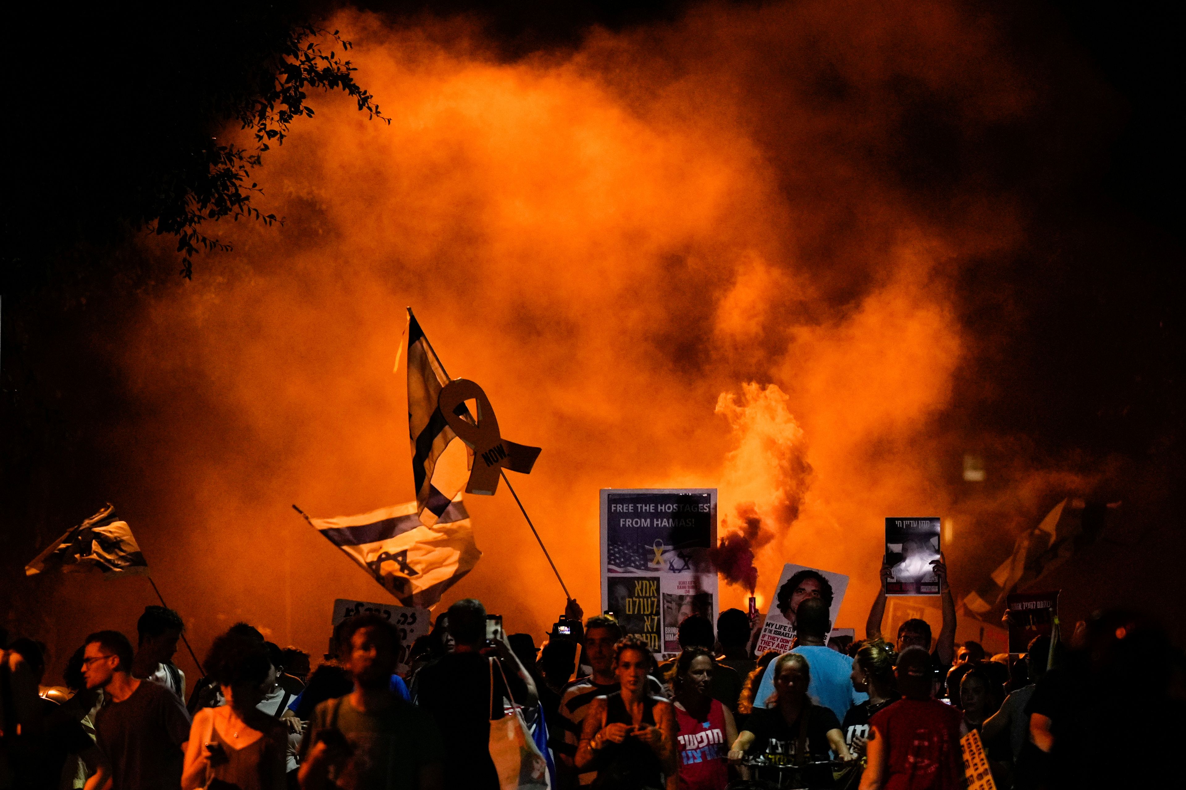 People attend a rally demanding a cease-fire deal and the immediate release of hostages held by Hamas in the Gaza Strip after the deaths of six hostages in the Palestinian territory in Tel Aviv, Israel, on Monday, Sept. 2, 2024. (AP Photo/Ariel Schalit)