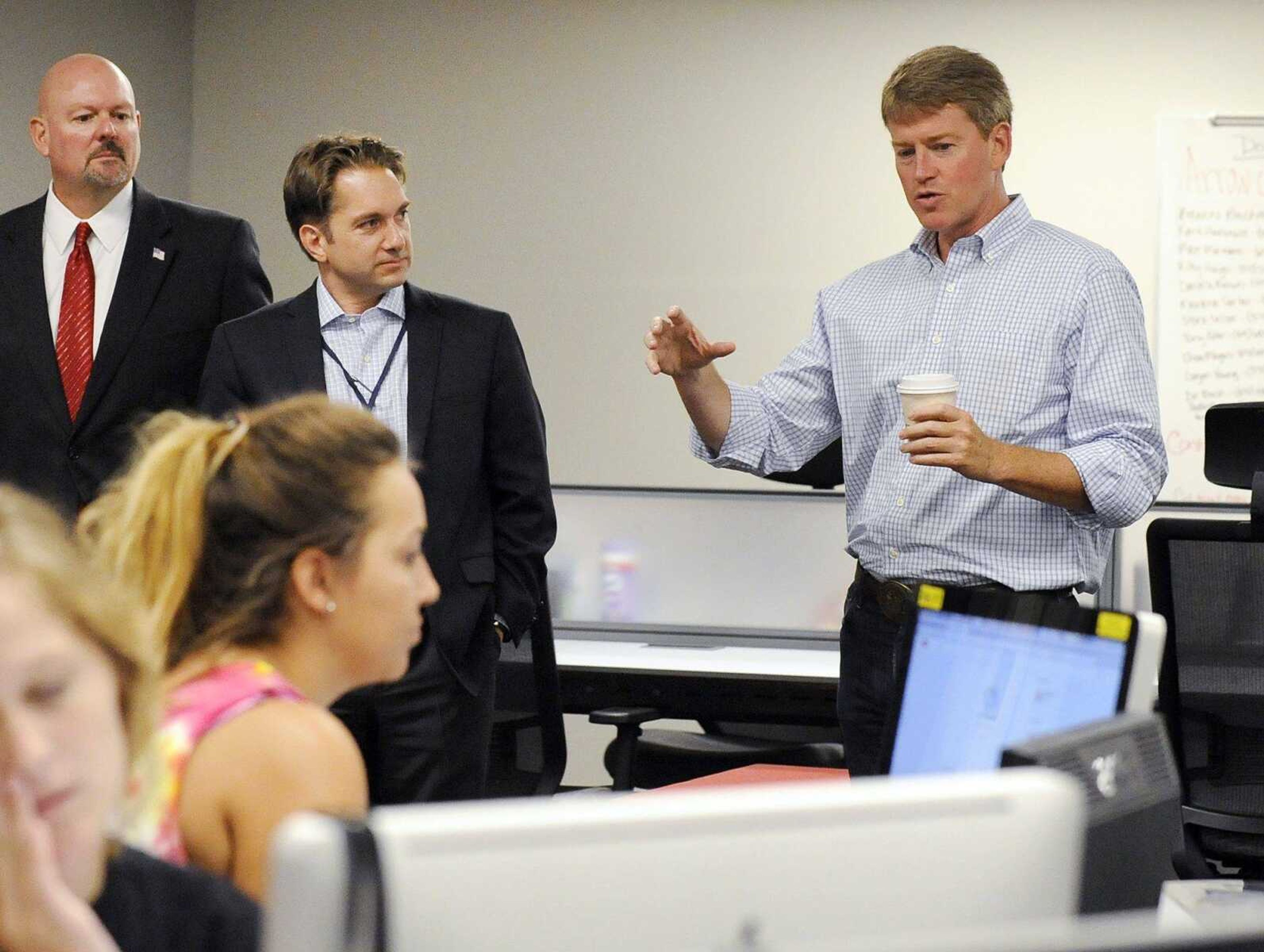 Jay Knudtson, left, and Jon K. Rust, publisher of the Southeast Missourian and co-president of Rust Communications, listen as Missouris Attorney General Chris Koster, right, speaks during a tour of Southeast Missouri State University's new Rust Center for Media on Thursday in Cape Girardeau. Koster is running for Missouri governor.