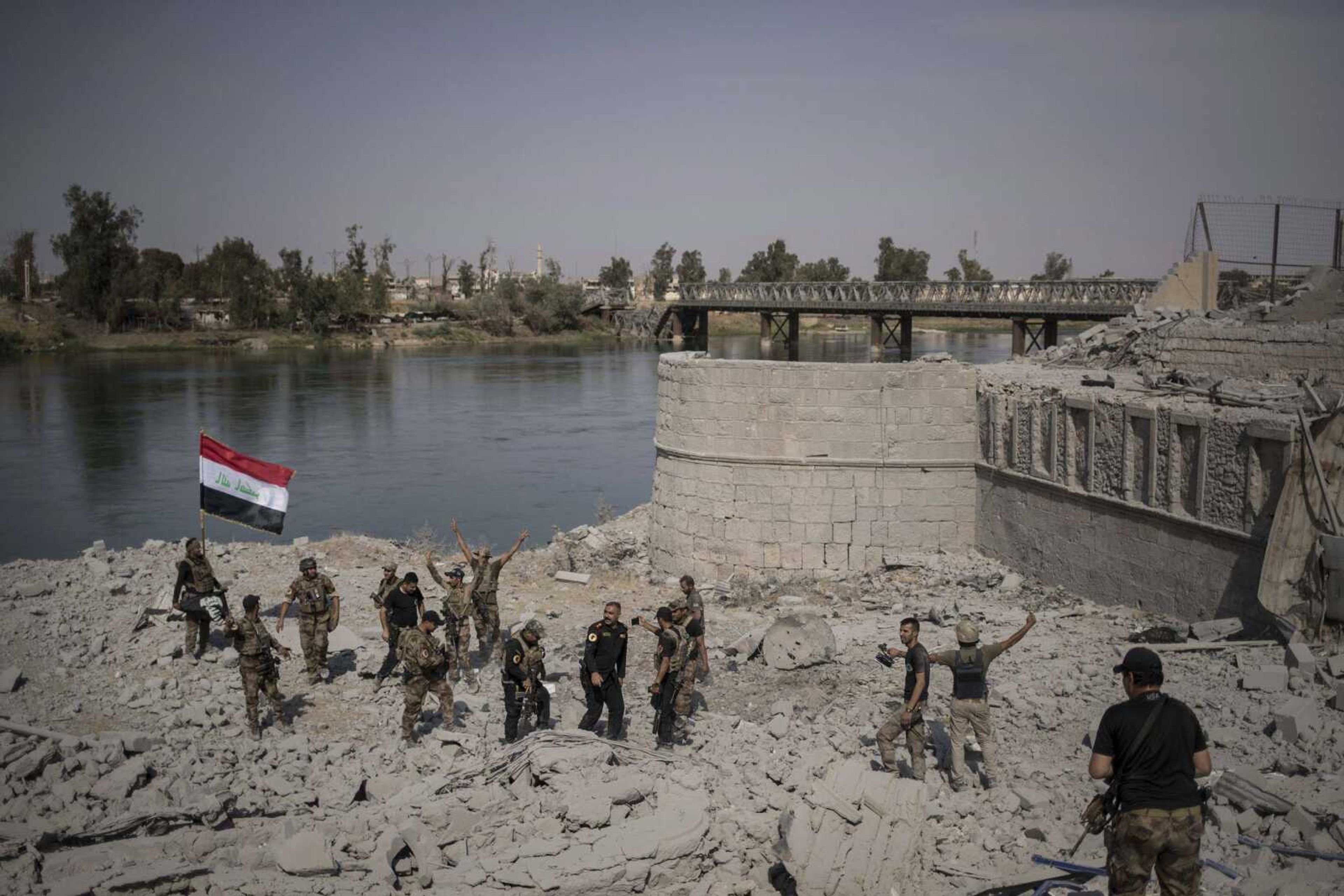 Iraqi Special Forces soldiers celebrate Sunday after reaching the bank of the Tigris River as their fight against Islamic State militants continues in parts of the Old City of Mosul, Iraq.