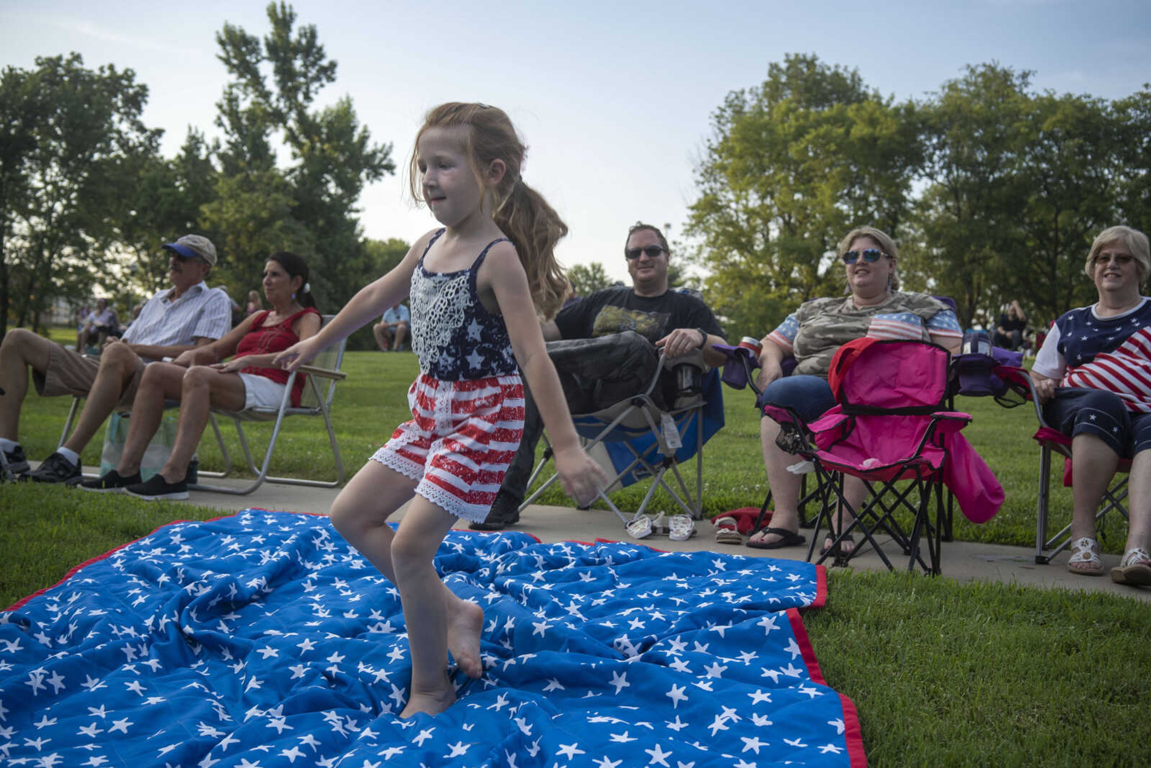 Nora Rubel, 6, dances as Shades of Soul plays Bruno Mars' "Uptown Funk" as her parents, Lori and Rory, background right, look on during an Independence Day celebration at the Jackson Municipal Band Shell.