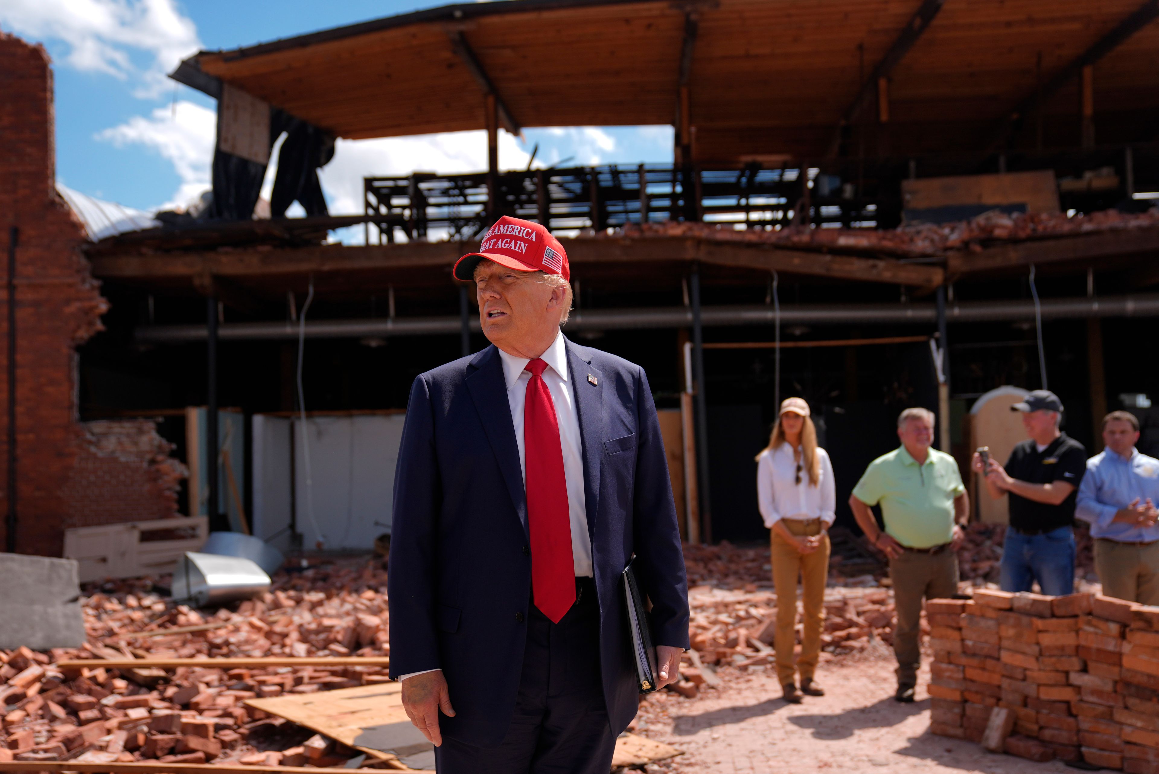 Republican presidential nominee former President Donald Trump speaks outside the Chez What furniture store as he visits Valdosta, Ga., a town impacted by Hurricane Helene, Monday, Sept. 30, 2024. (AP Photo/Evan Vucci)