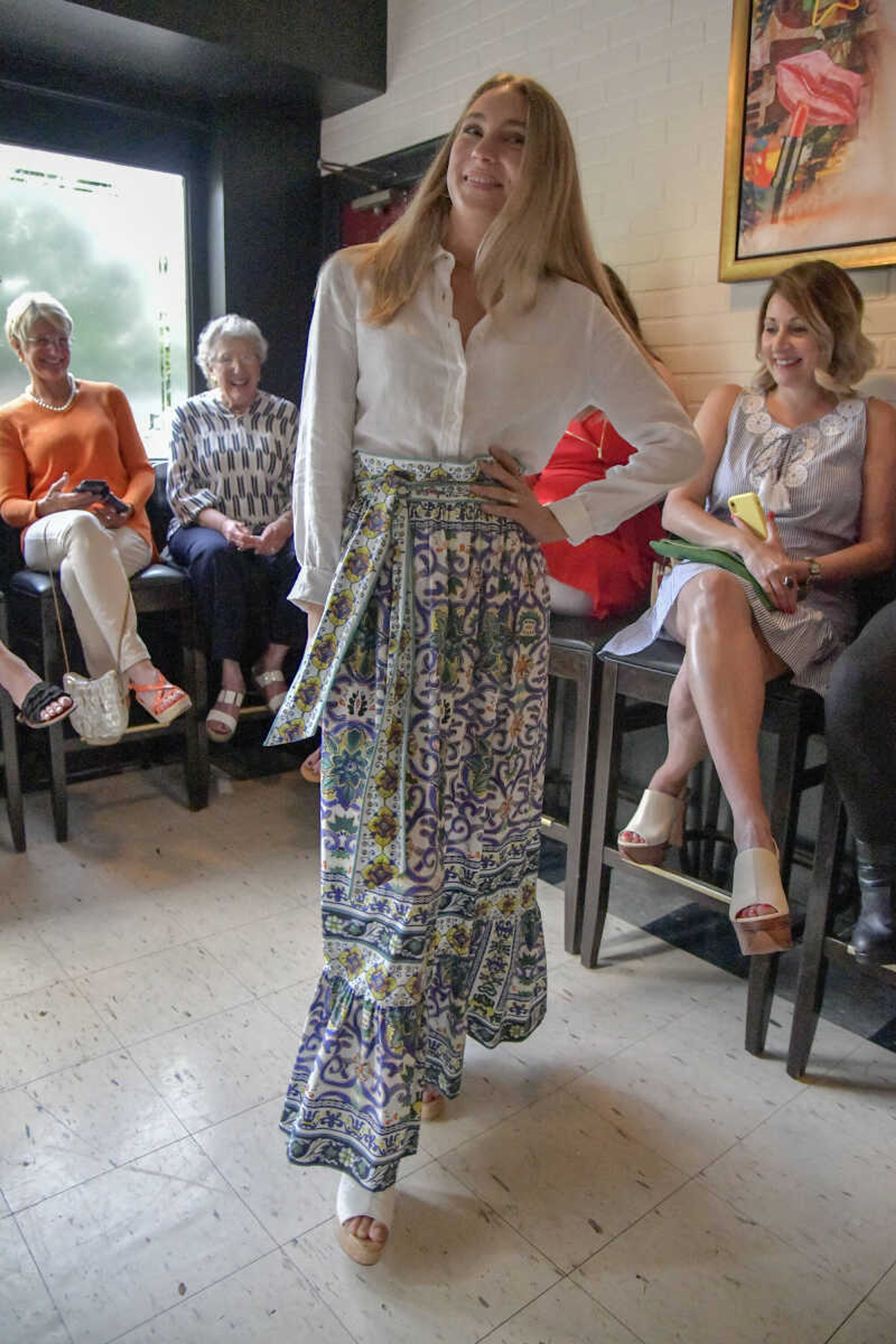 Minna Straus models a patterned skirt with a linen blouse during the Aesthete Luxury Resale fashion show at Le Bistro at The Bar in Cape Girardeau on Tuesday, June 8, 2021.