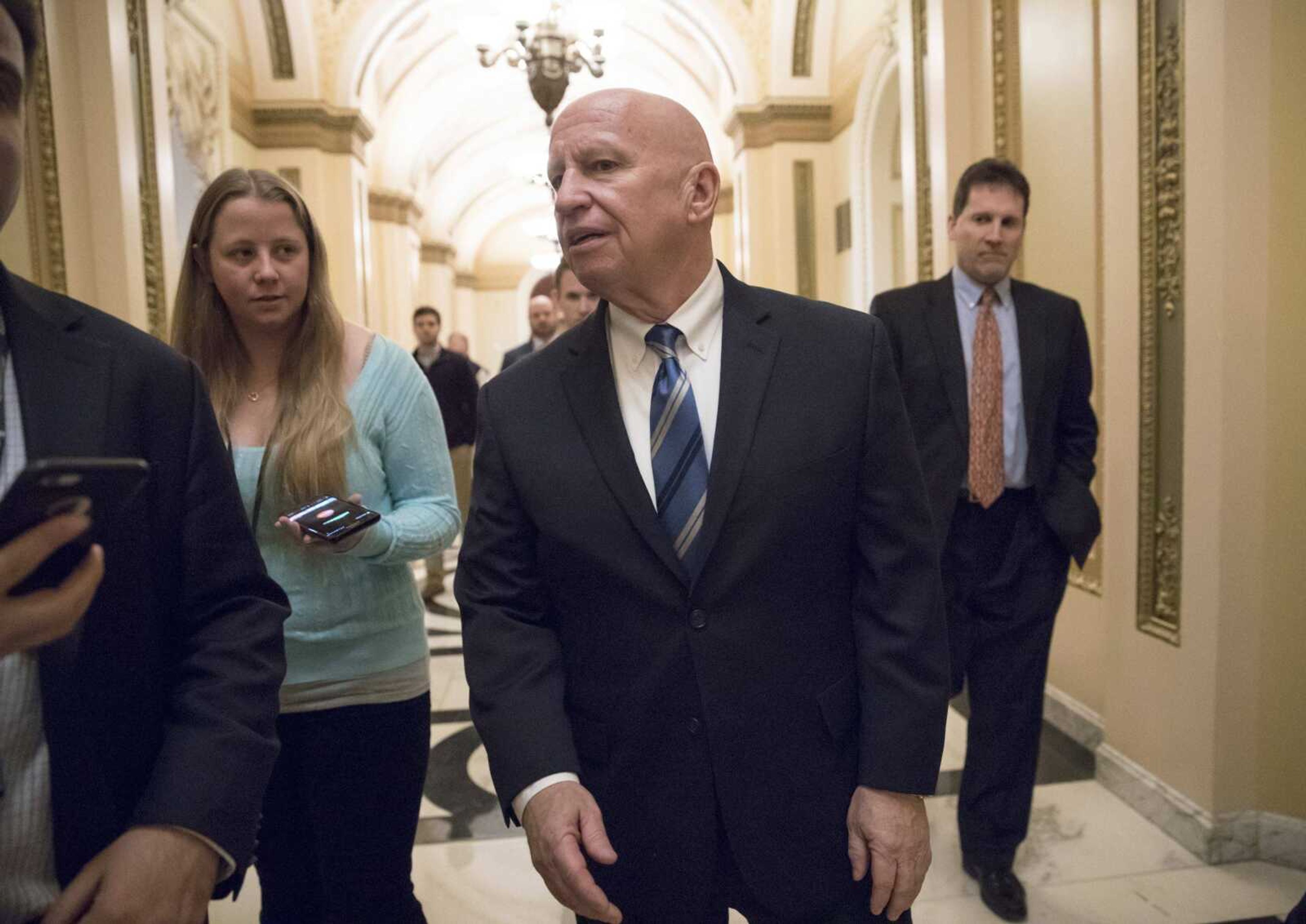 House Ways and Means Committee chairman Kevin Brady, R-Texas, walks in the Capitol after signing the conference committee report Friday to advance the GOP tax bill in Washington.