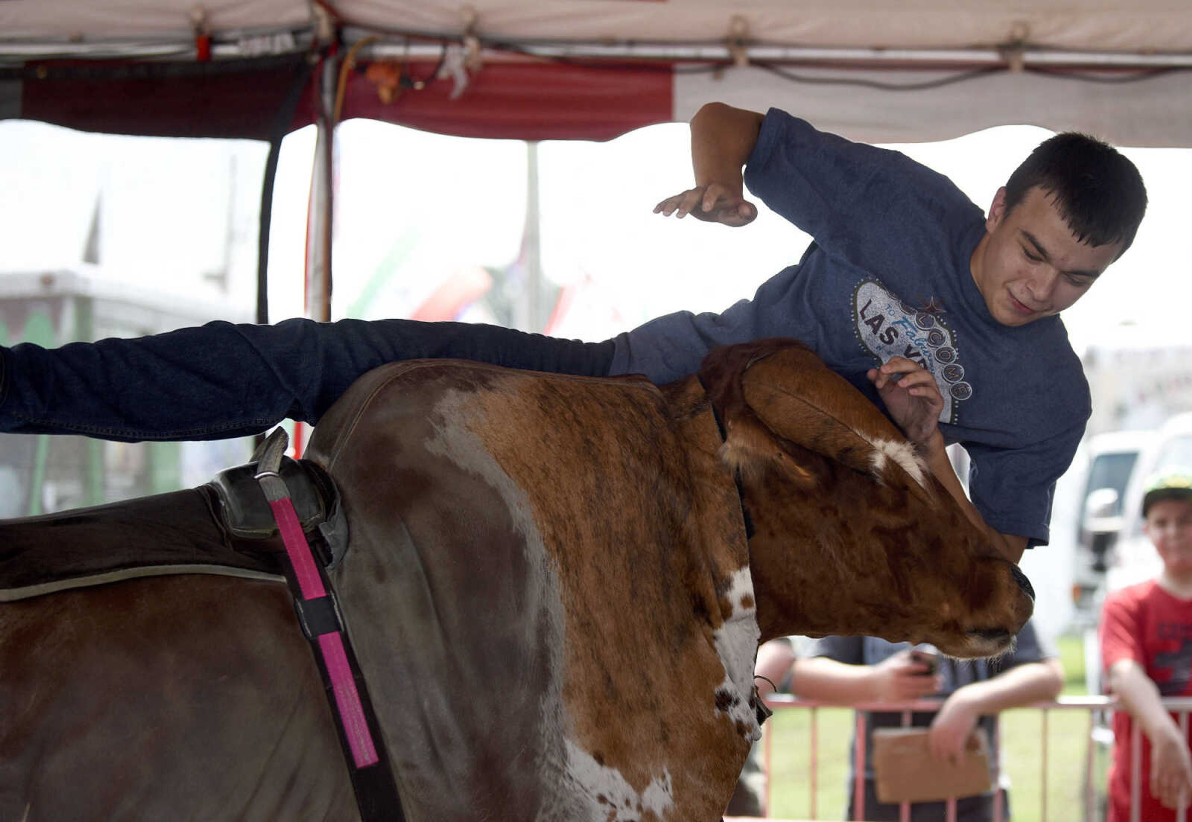 LAURA SIMON ~ lsimon@semissourian.com

People take a shot at the mechanical bull in the 8 Seconds Productions booth at the SEMO District Fair on Friday, Sept. 16, 2016, at Arena Park in Cape Girardeau.