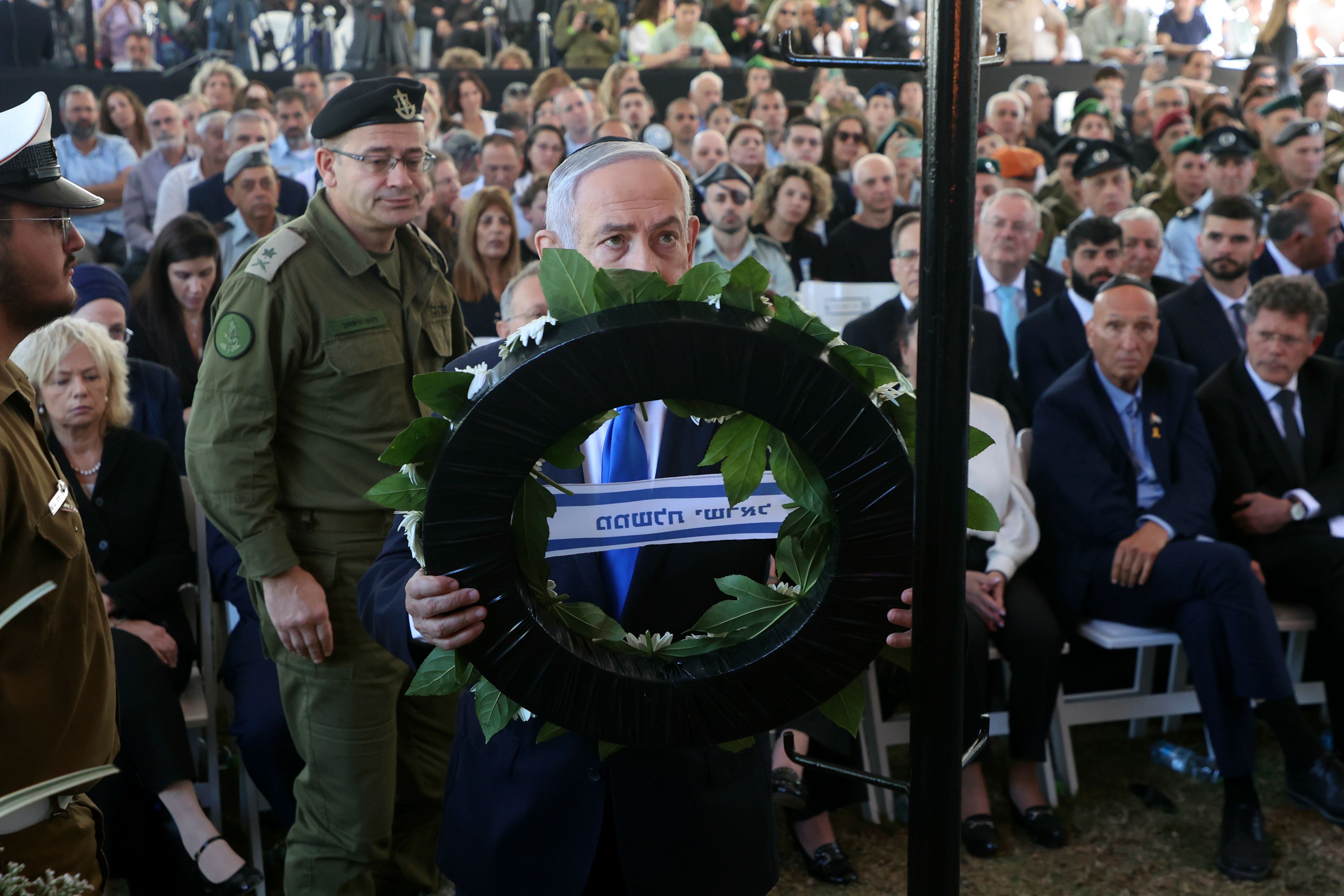 Israel's Prime Minister Benjamin Netanyahu takes part in a ceremony marking the Hebrew calendar anniversary of the Hamas attack on October 7 last year that sparked the ongoing war in Gaza, at the Mount Herzl military cemetery in Jerusalem, Israel Sunday Oct. 27, 2024. (Gil Cohen-Magen/Pool Photo via AP)