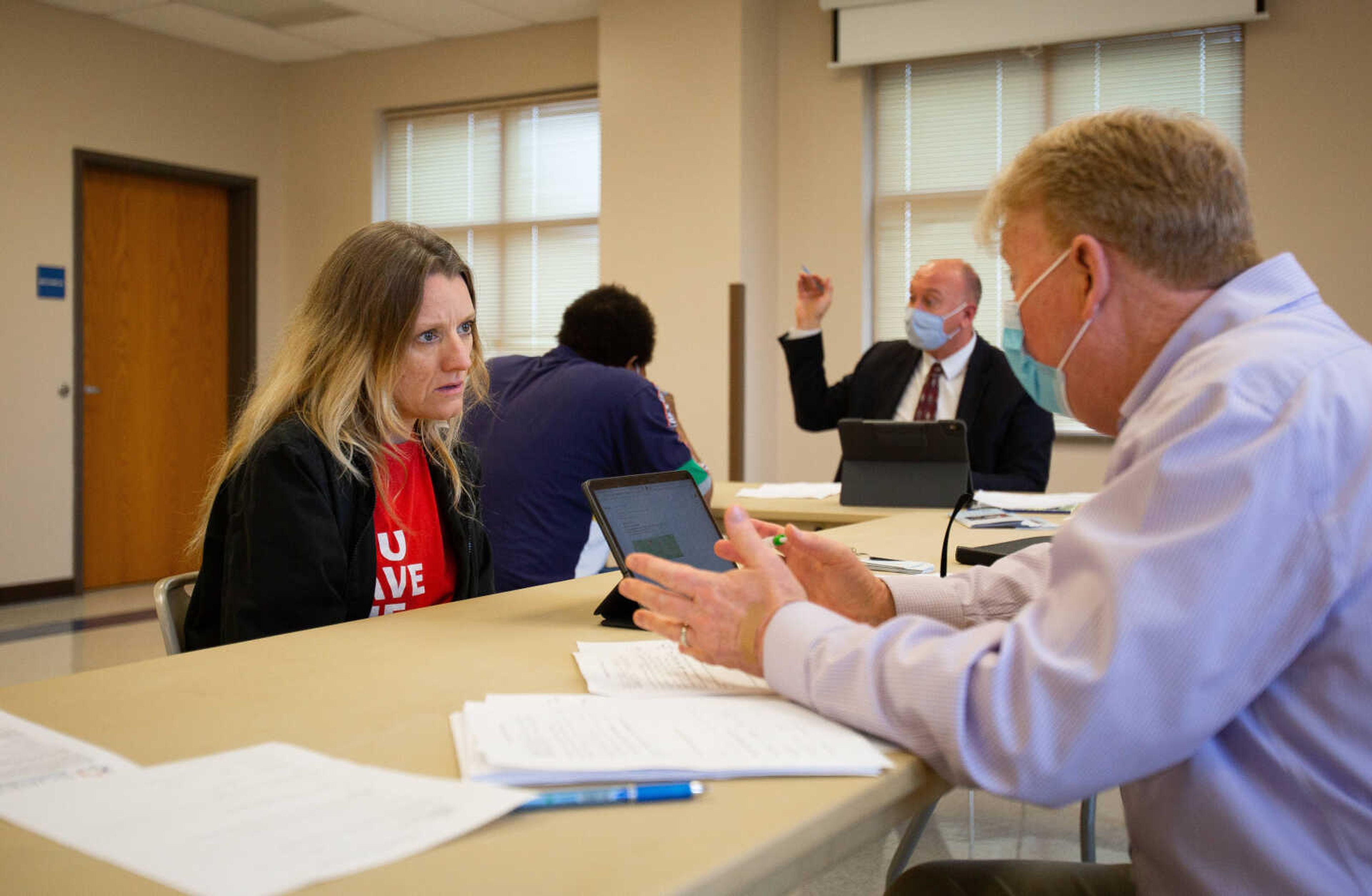 Lisa Green listens intently as Lew Polivick, deputy director of Legal Services of Southern Missouri, explains the process of expungement during a clinic at Project C.A.P.E. on Thursday, March 25, 2021. Green, who has sought employment as a nurse, has been held back by a decade-old misdemeanor on her record.