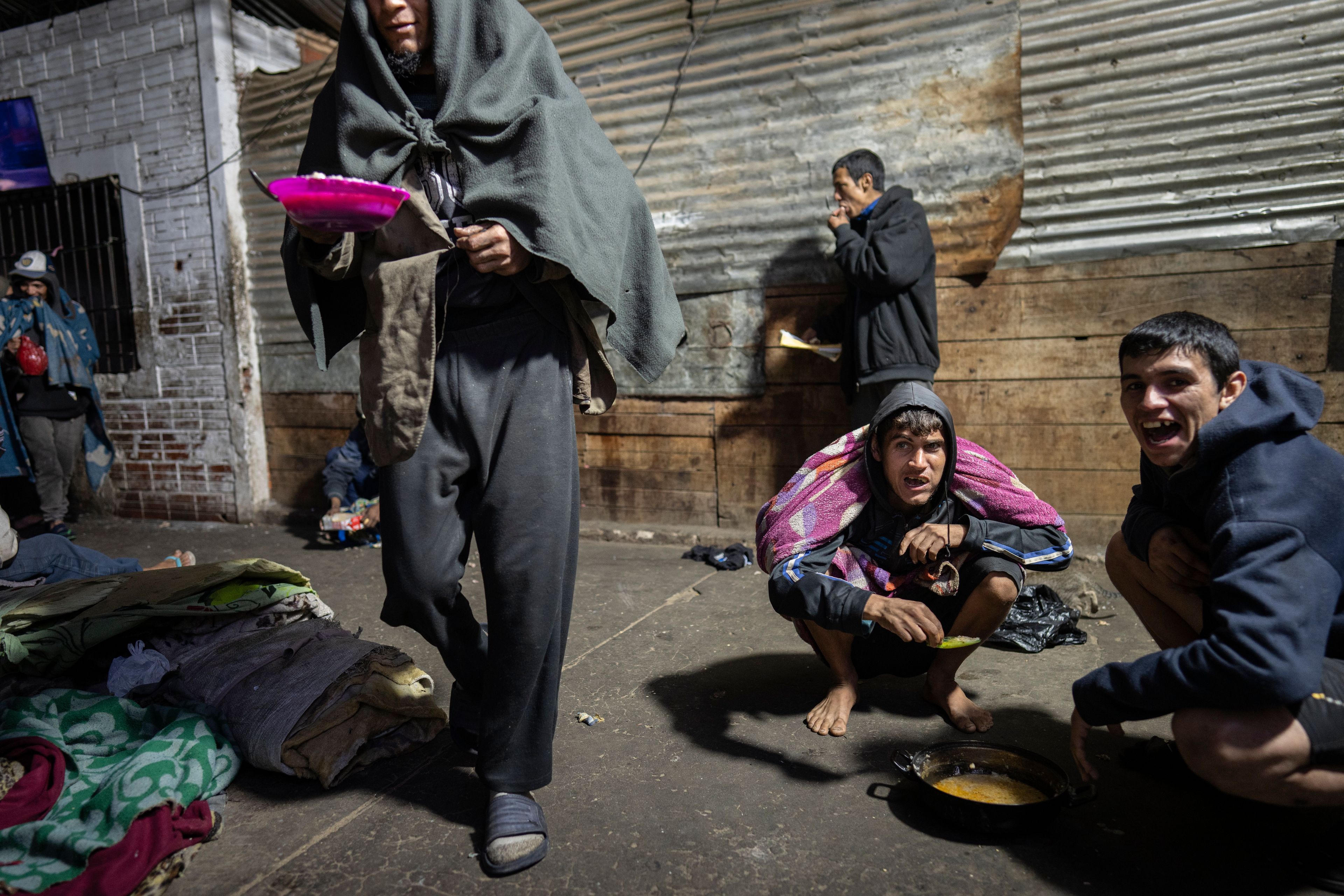 Prisoners eat a jail-provided soup known as "vori vori" at the Tacumbu prison in Asuncion, Paraguay, Sunday, July 8, 2024. The soup, made of chicken or beef, vegetables, and corn balls stuffed with cheese, is considered the food of the poorest inmates, and those who can afford to buy other food don't eat it. (AP Photo/Rodrigo Abd)