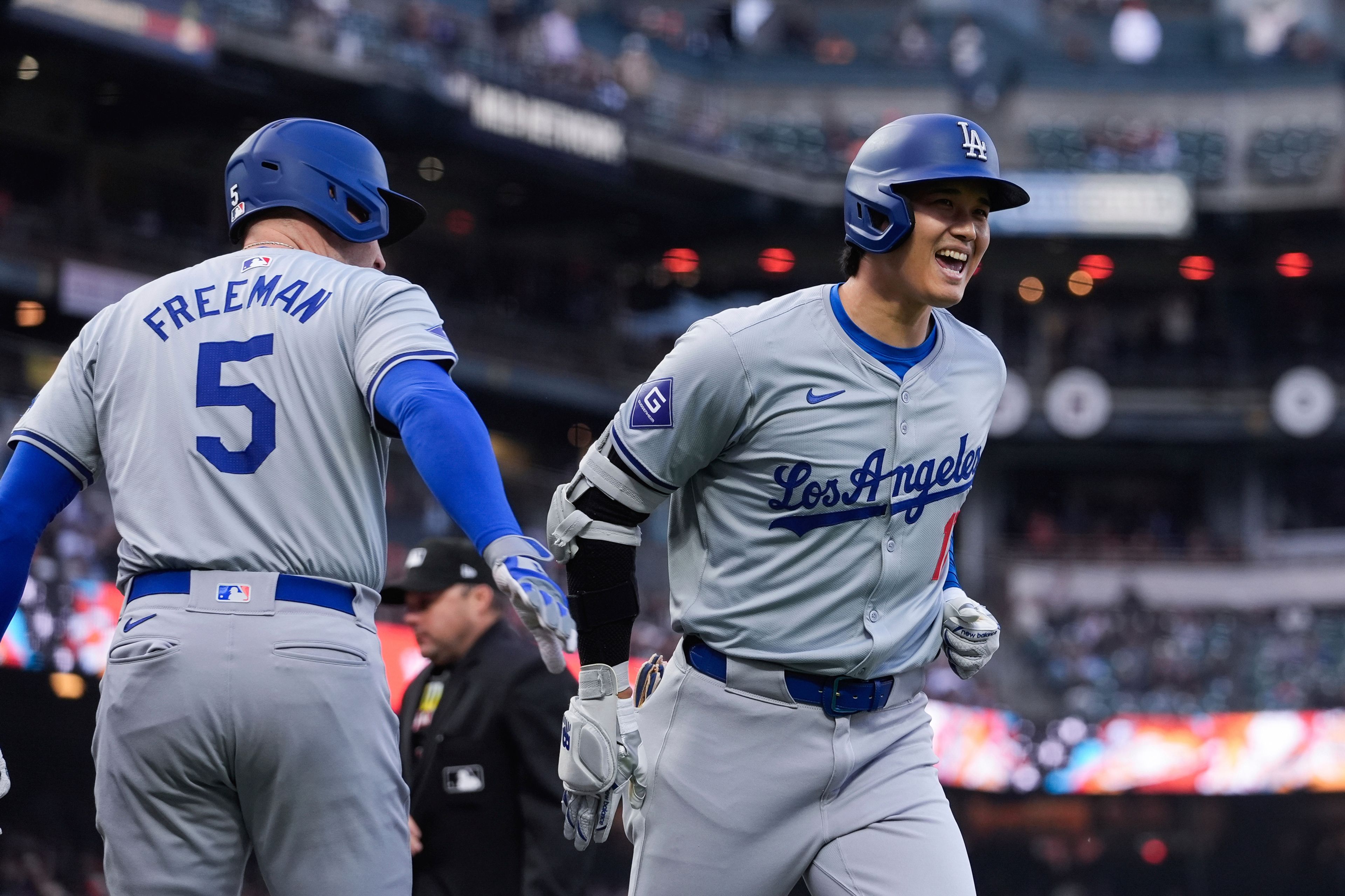 Los Angeles Dodgers' Shohei Ohtani, right, is congratulated by Freddie Freeman after his solo home run against the San Francisco Giants during the fourth inning of a baseball game Tuesday, May 14, 2024, in San Francisco. (AP Photo/Godofredo A. Vásquez)